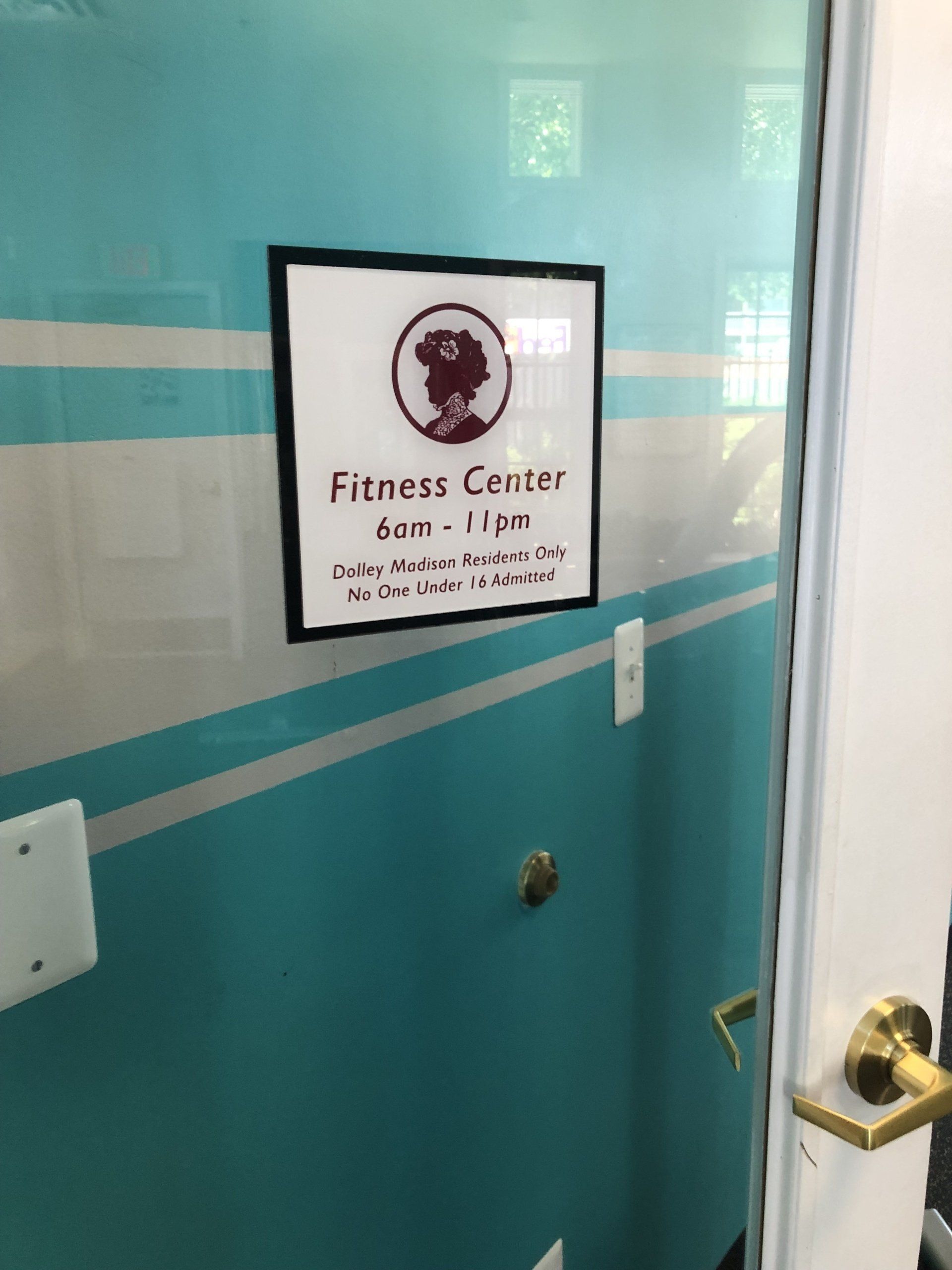 A sign on a door that says fitness center