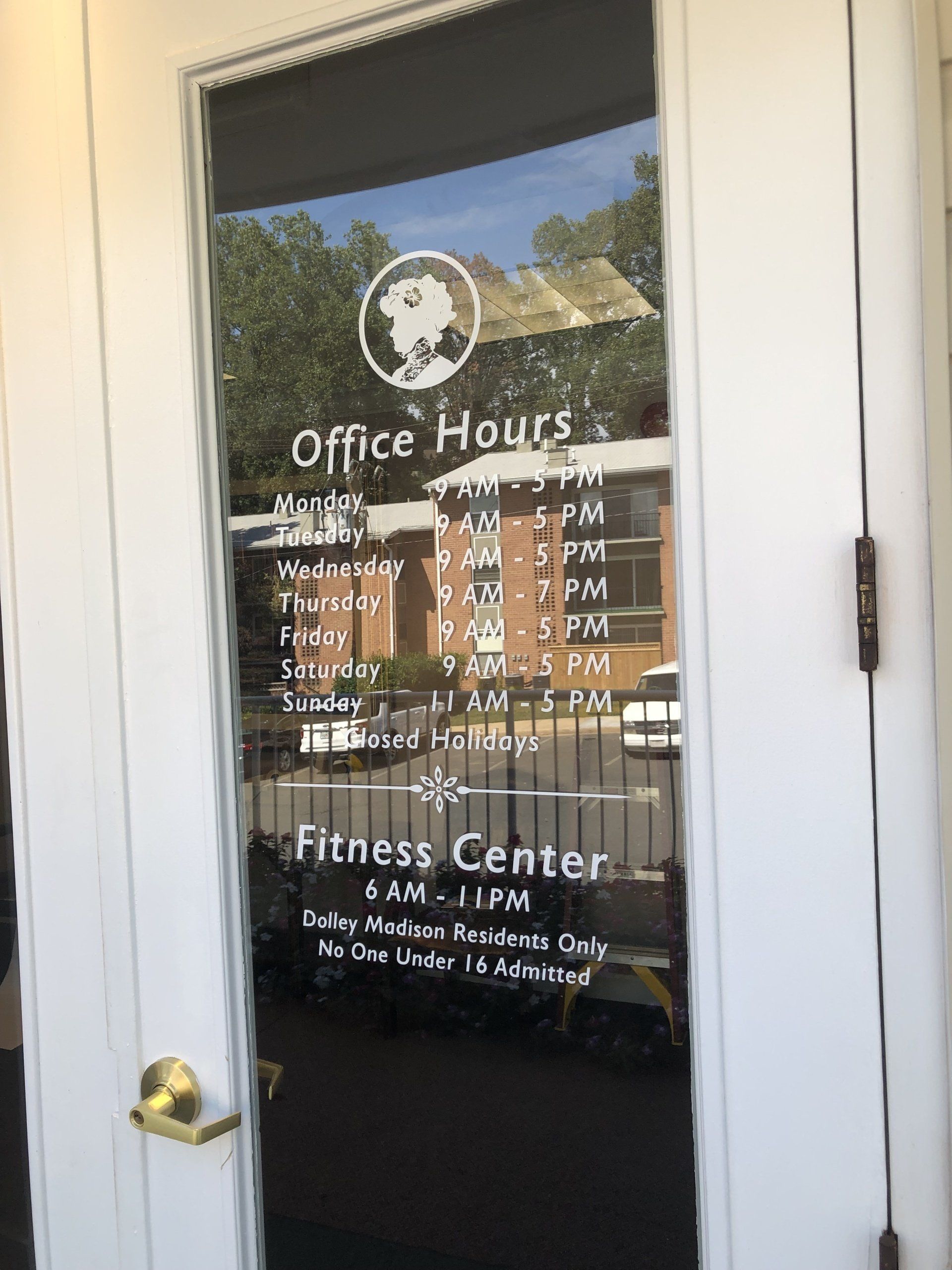 A door with a sign on it that says `` office hours '' and `` fitness center ''.