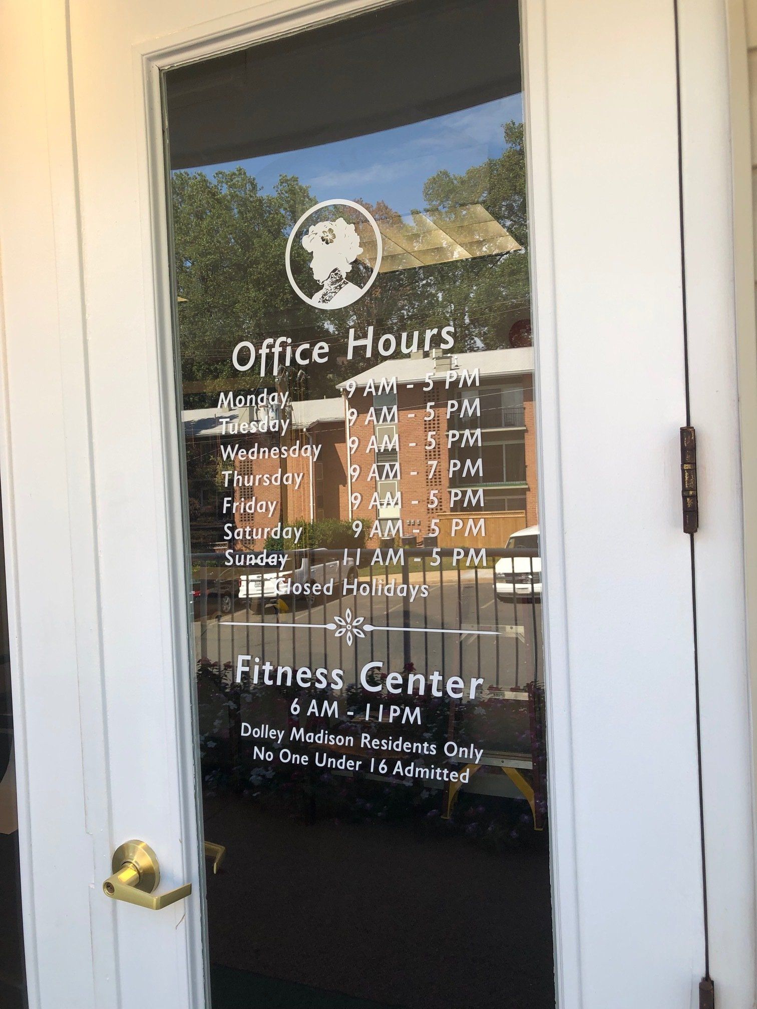 A door with a sign on it that says `` office hours '' and `` fitness center ''.