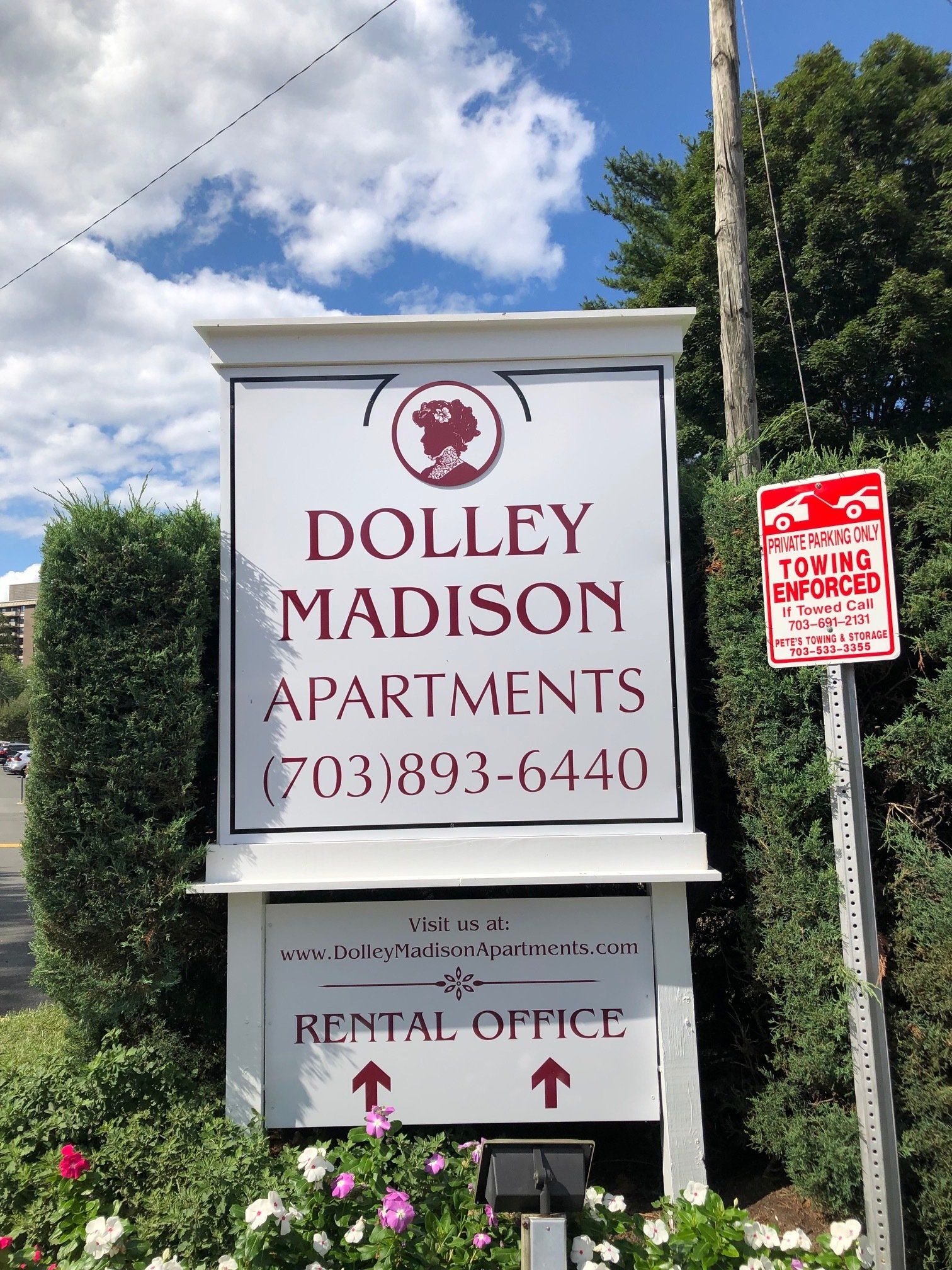 A sign for dolly madison apartments is on a pole