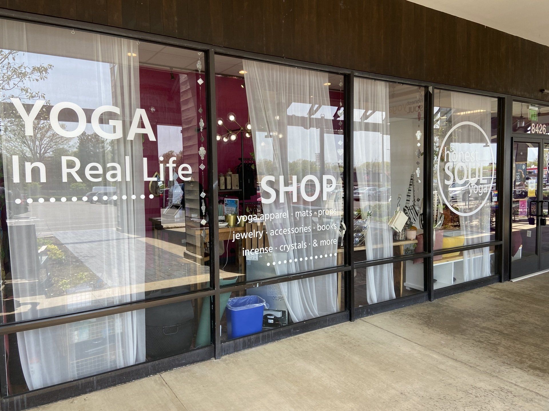 The front of a yoga in real life shop with a lot of windows.