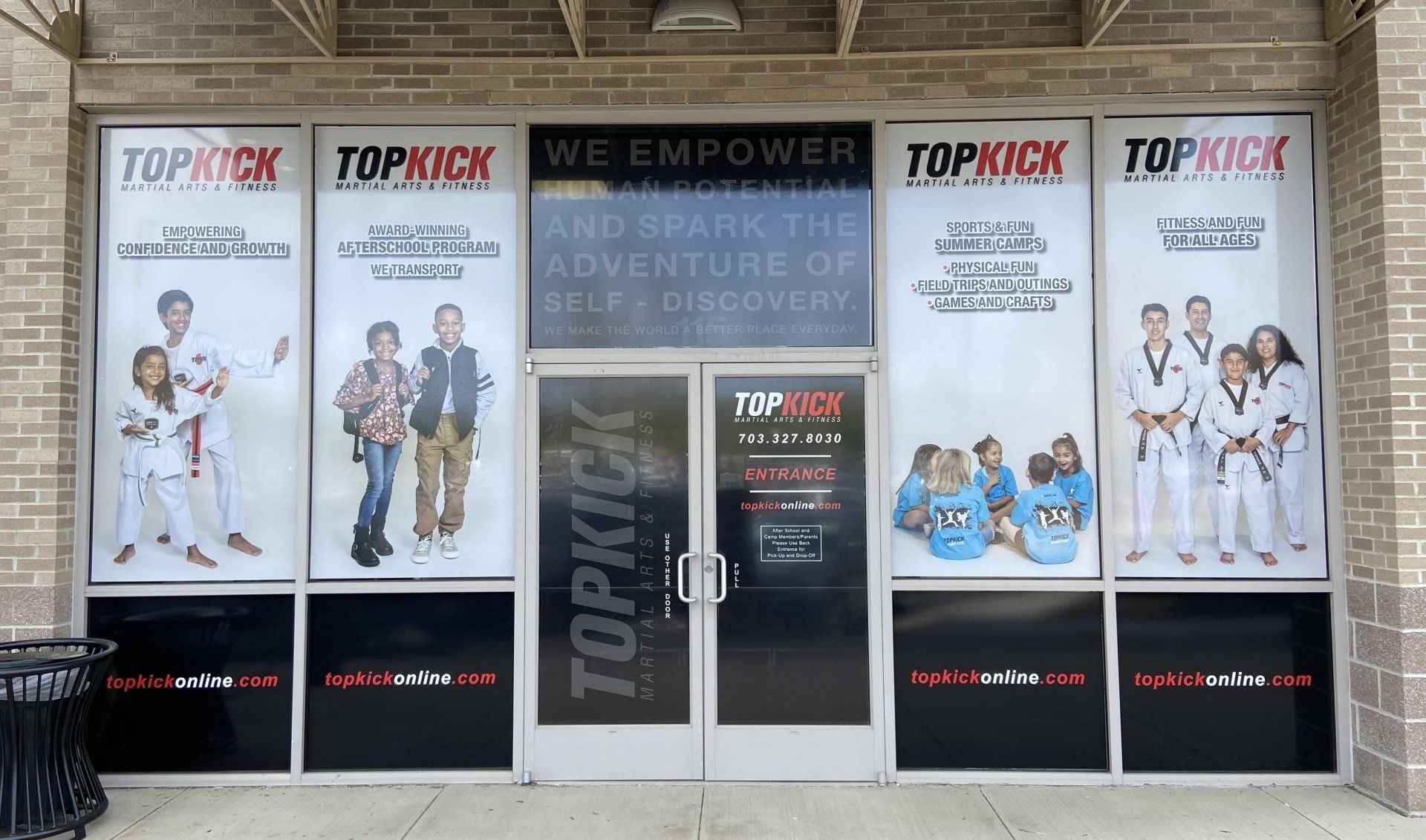 The front of a taekwondo school with a lot of posters on the windows.