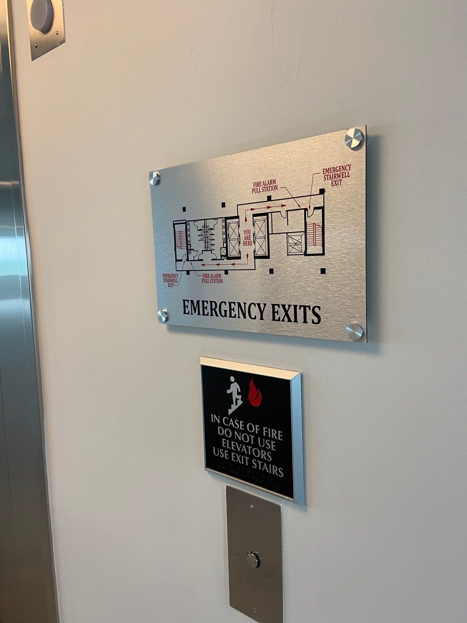There is a sign on the wall that says `` emergency exits ''.