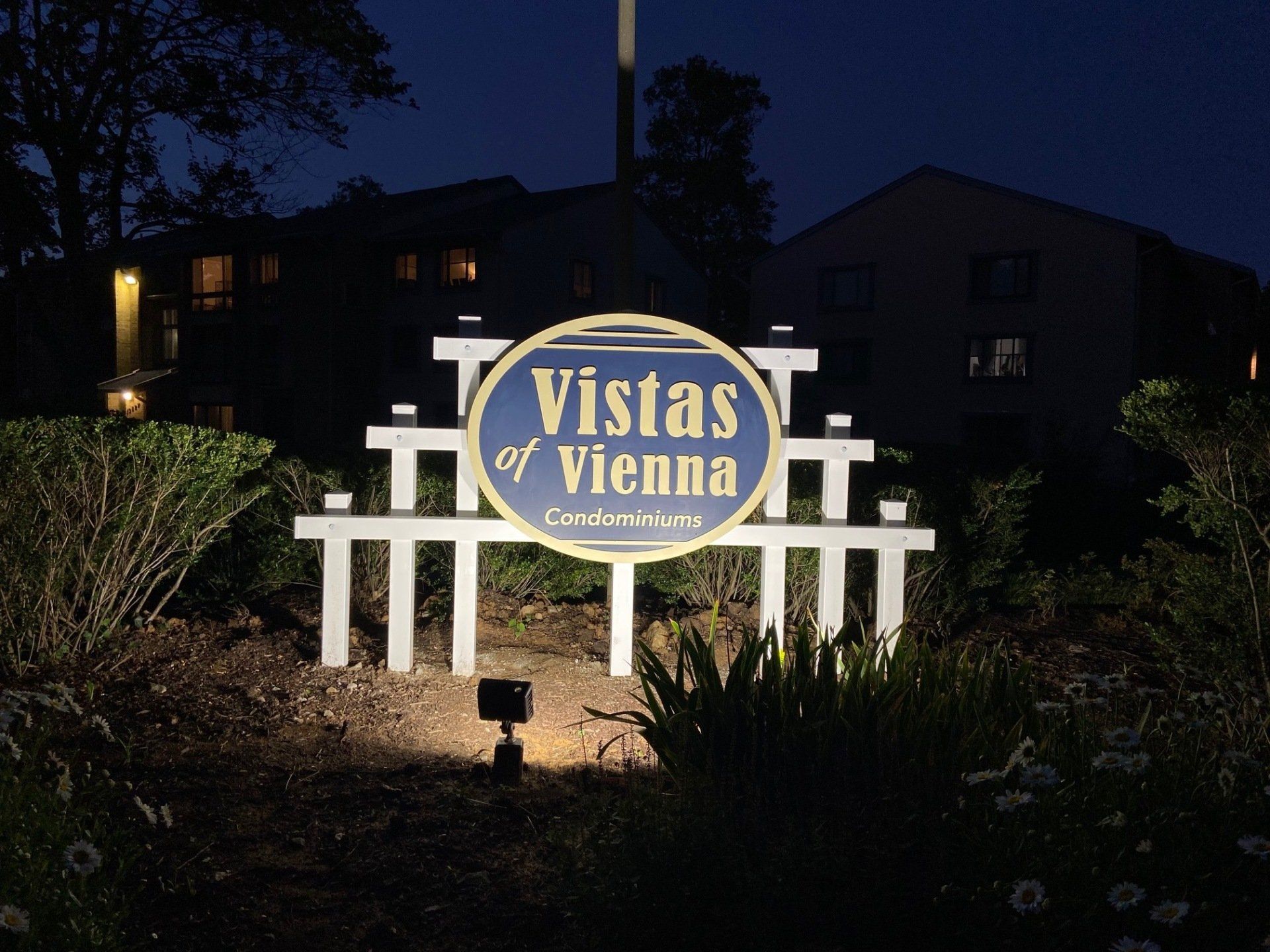 A sign for vistas of vienna is lit up at night