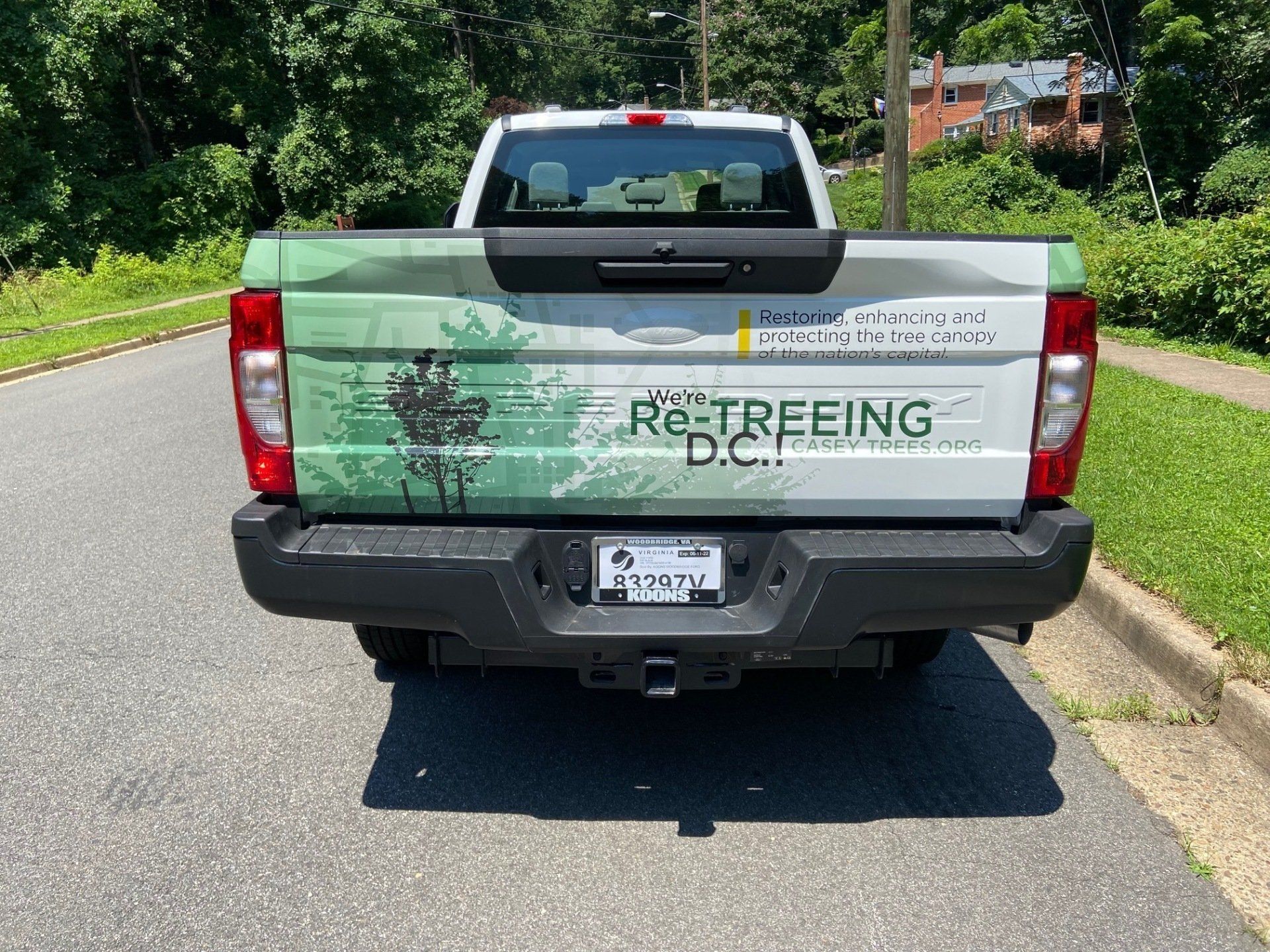 A white truck is parked on the side of the road.