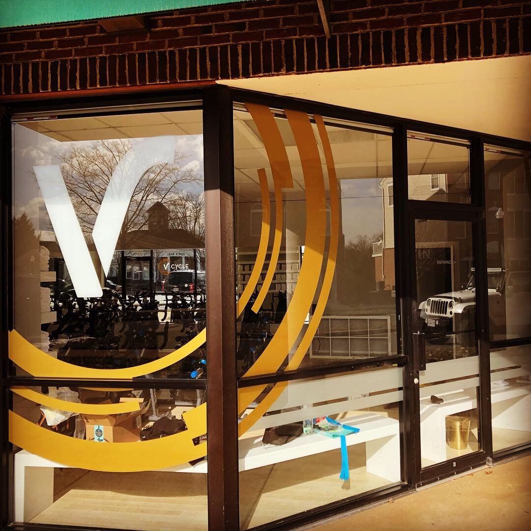 A store front with a yellow and white logo on it