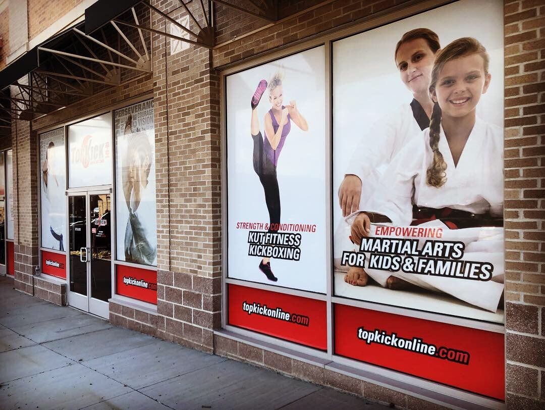 A store front with a sign that says martial arts for kids and families