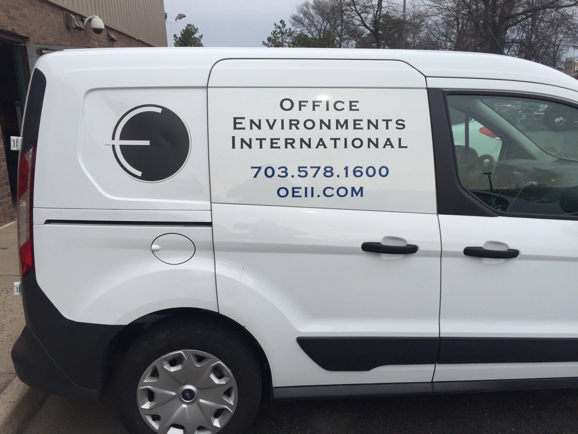 A white van that says office environments international on the side