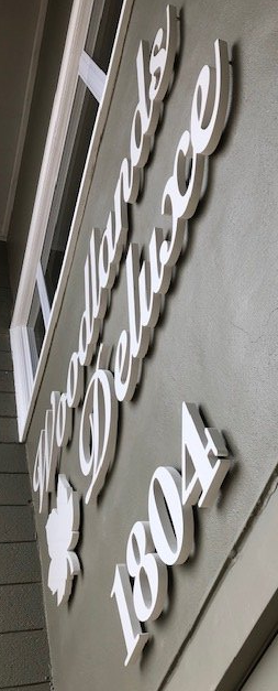 A close up of a sign on the side of a building.