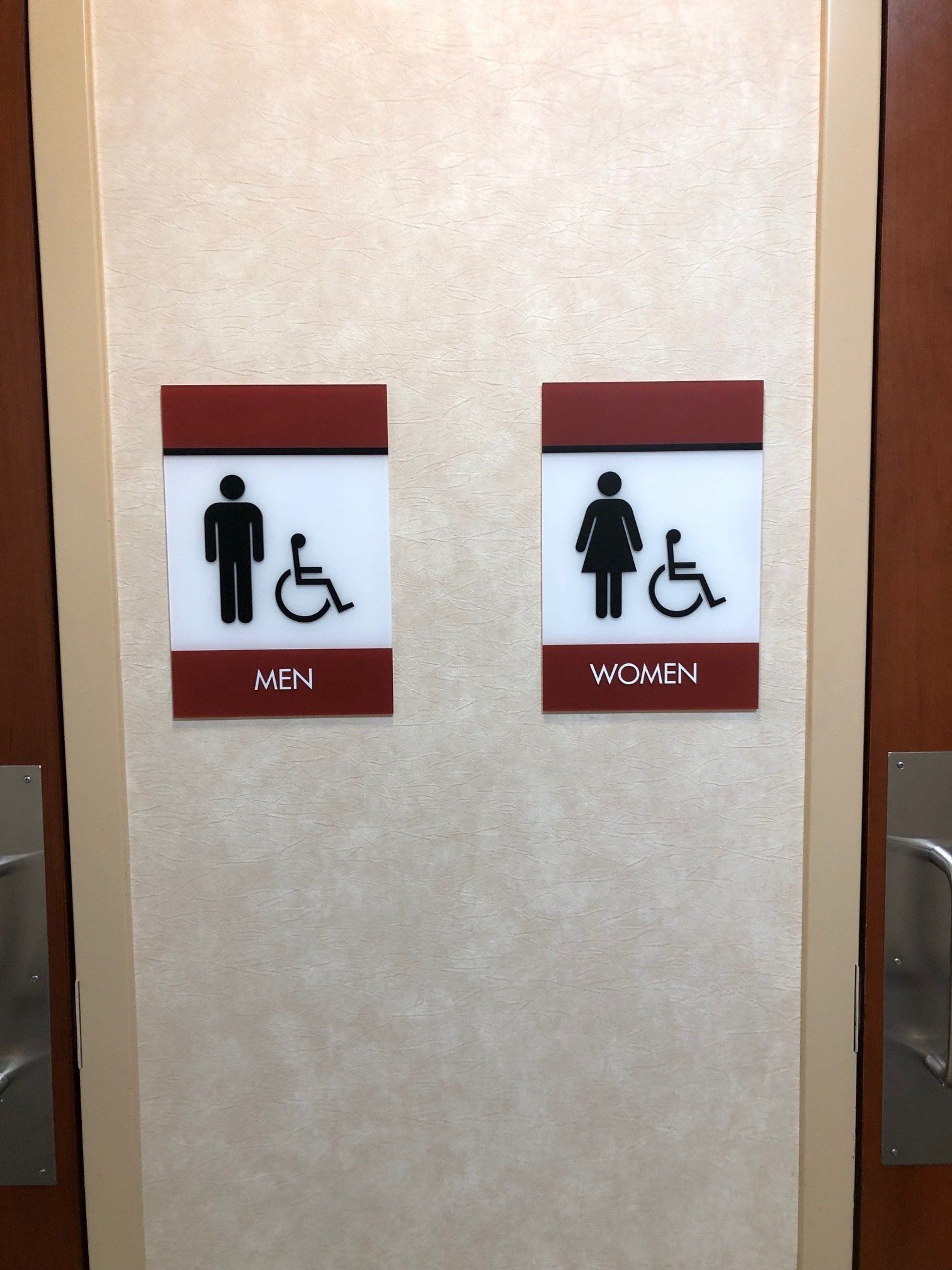 Two signs on a wall that say men and women