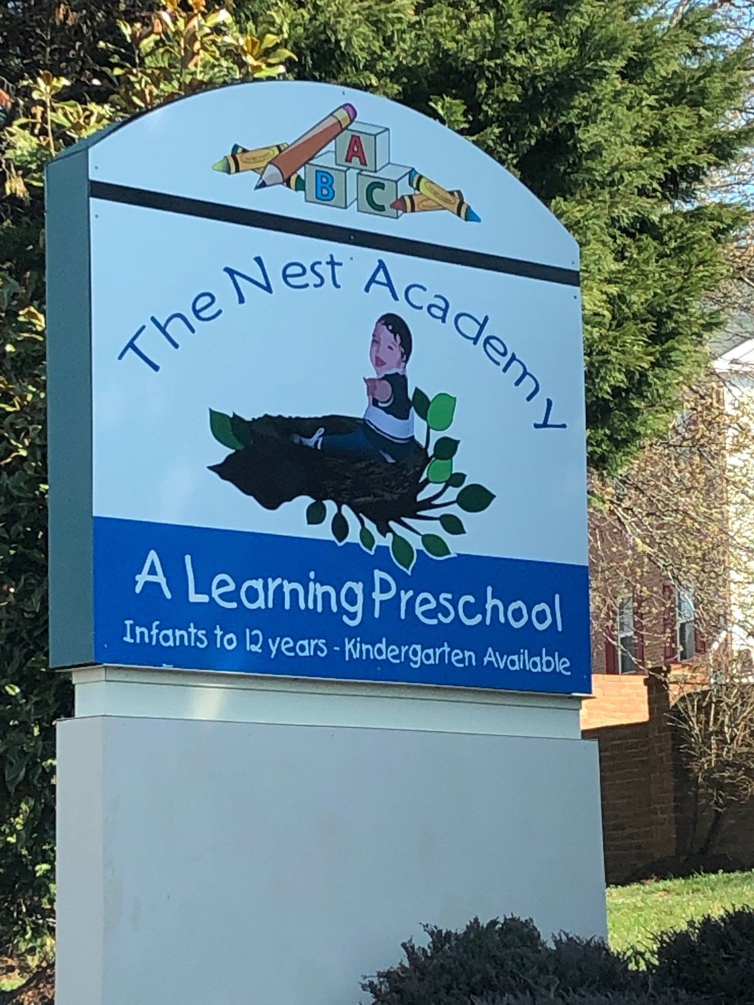 A sign for the nest academy a learning preschool
