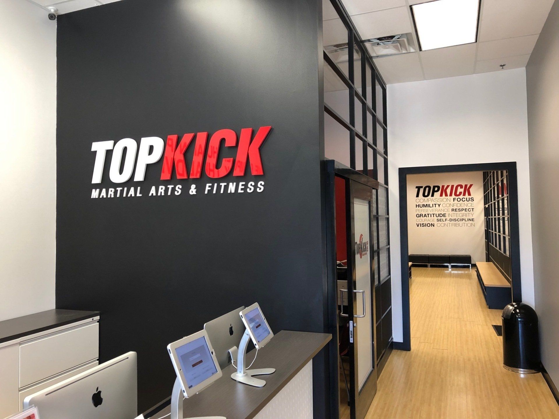 A room with a sign that says topkick martial arts and fitness