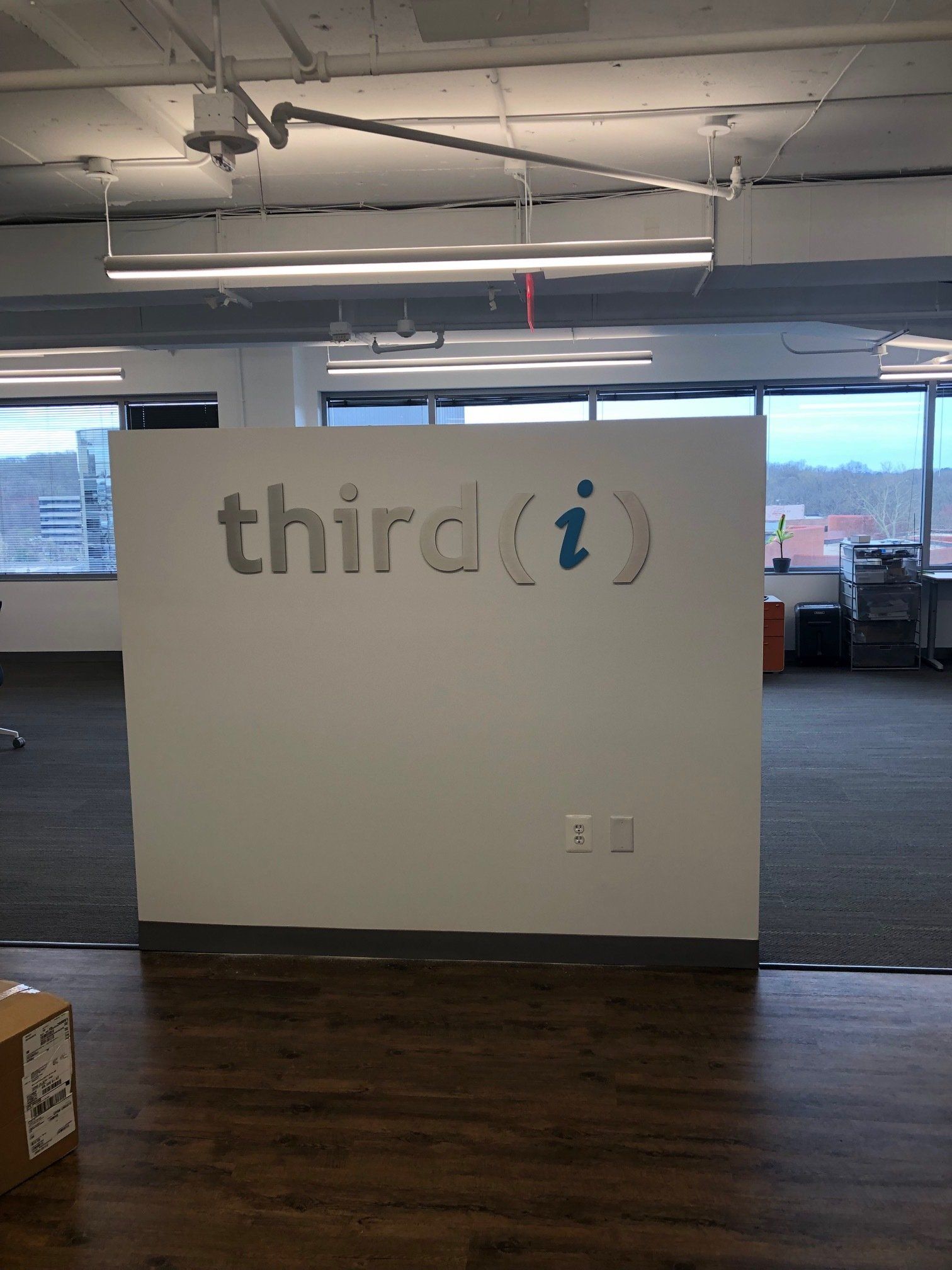 A white wall with the word third on it