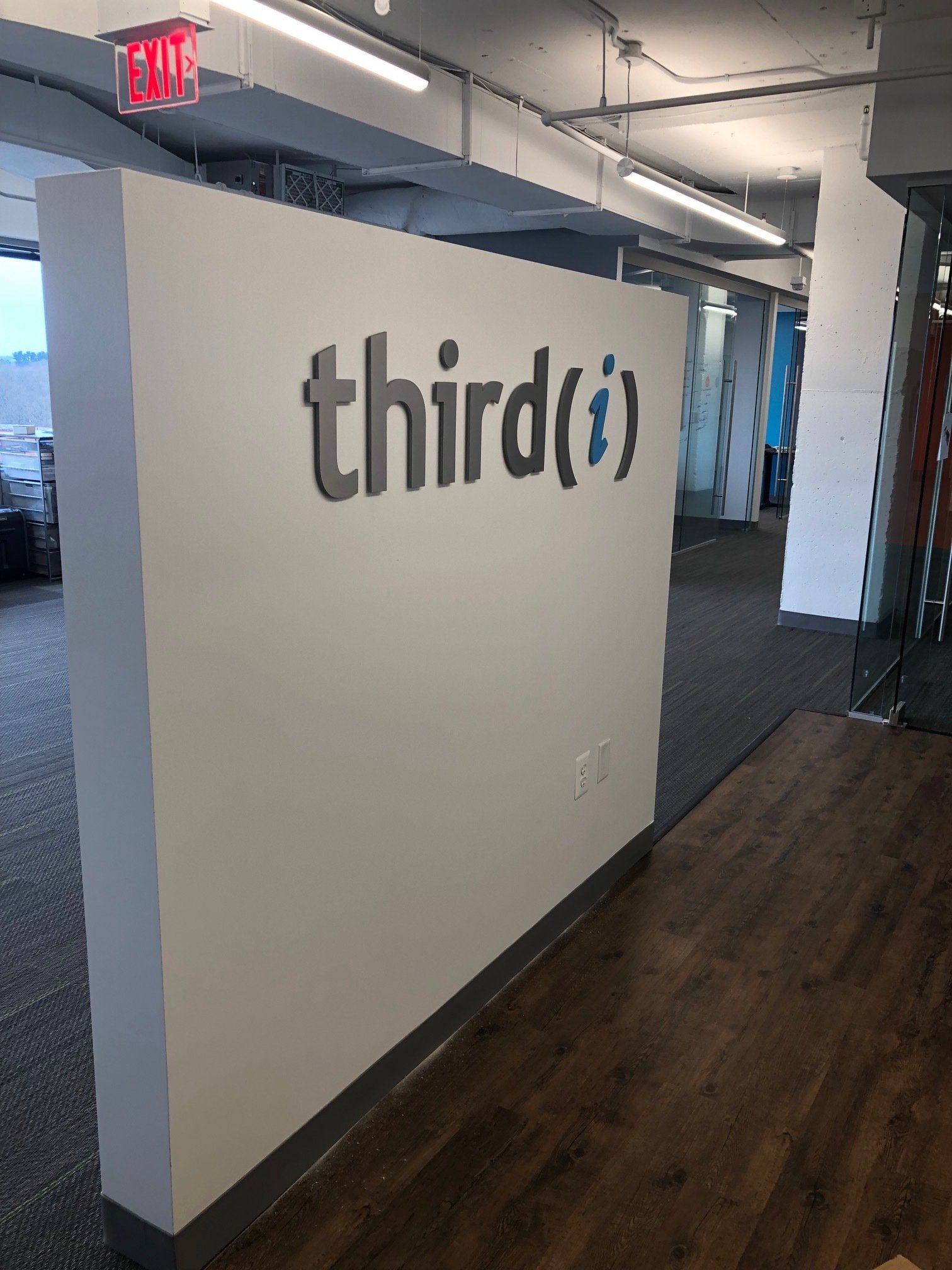 A white wall with the word third on it