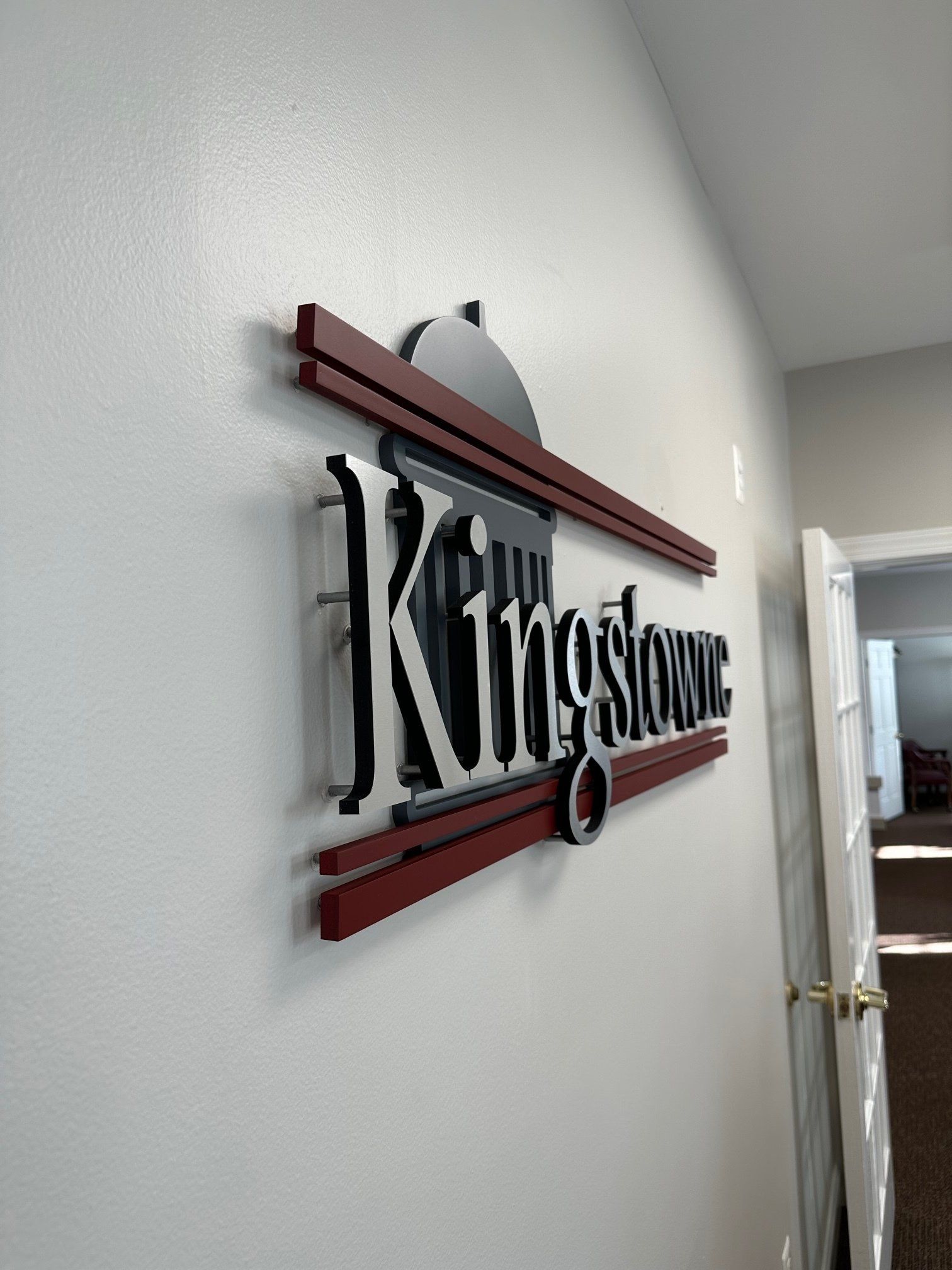 A white wall with a sign that says kingstown on it