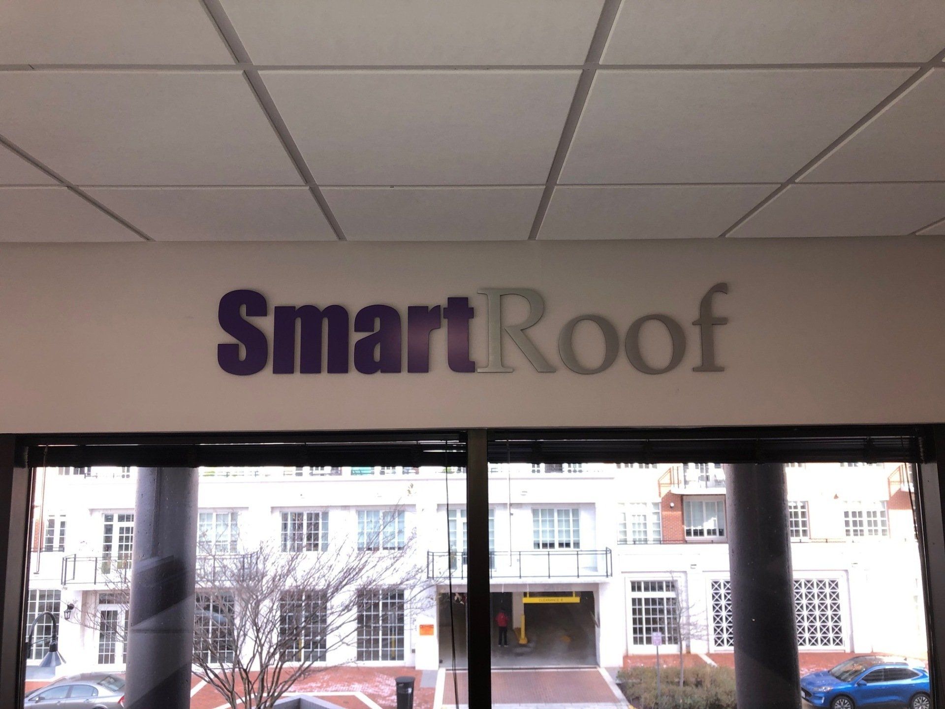 A sign on a wall that says smart roof