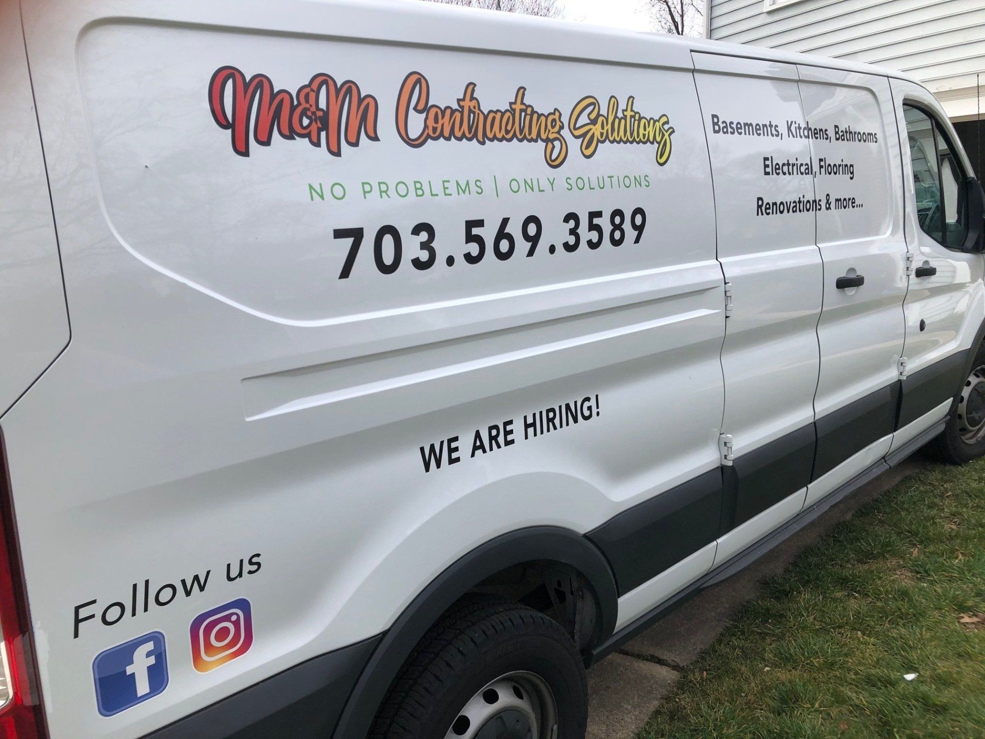 A white van is parked on the side of the road.