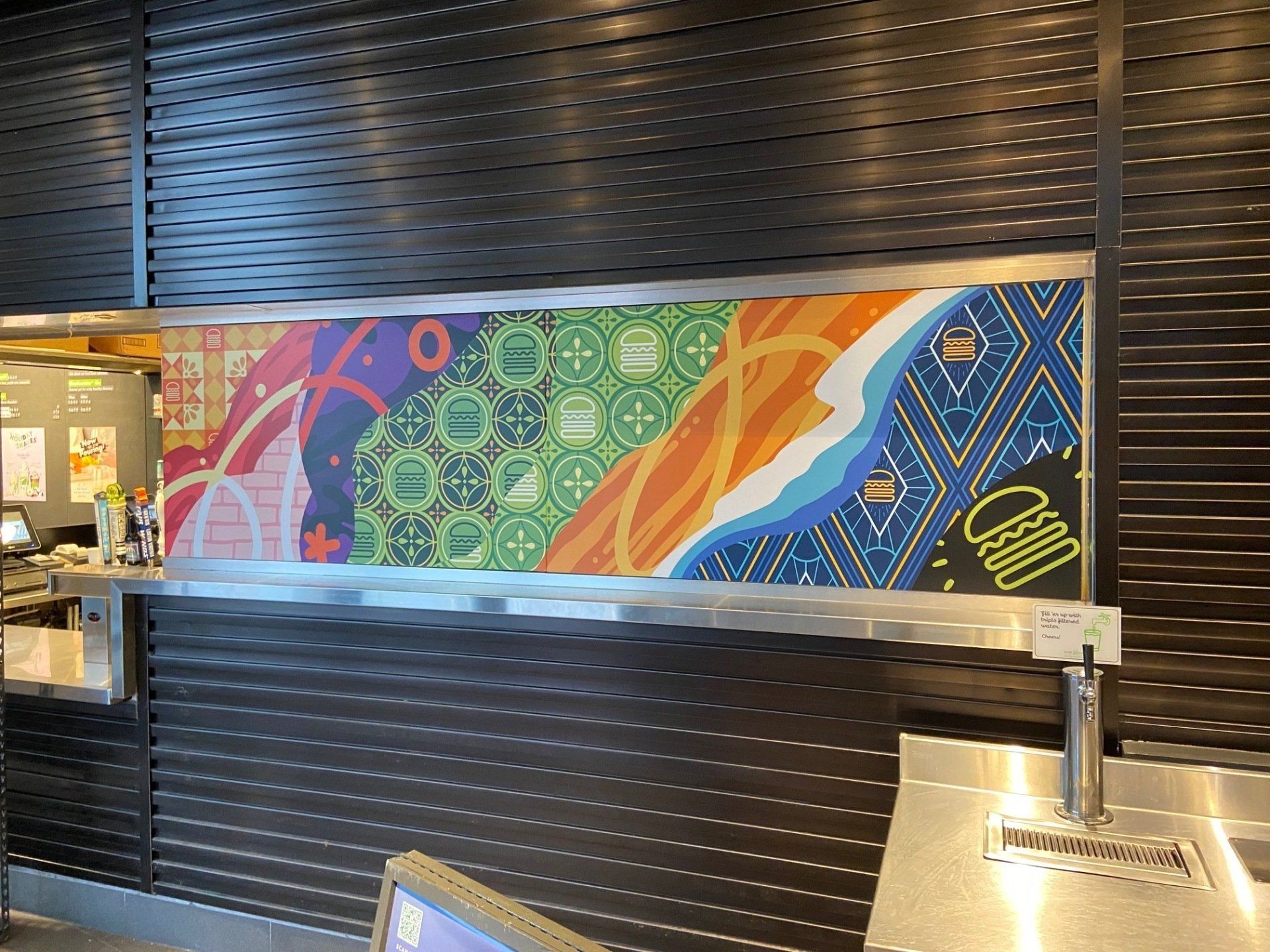 A colorful painting on a wall in a restaurant