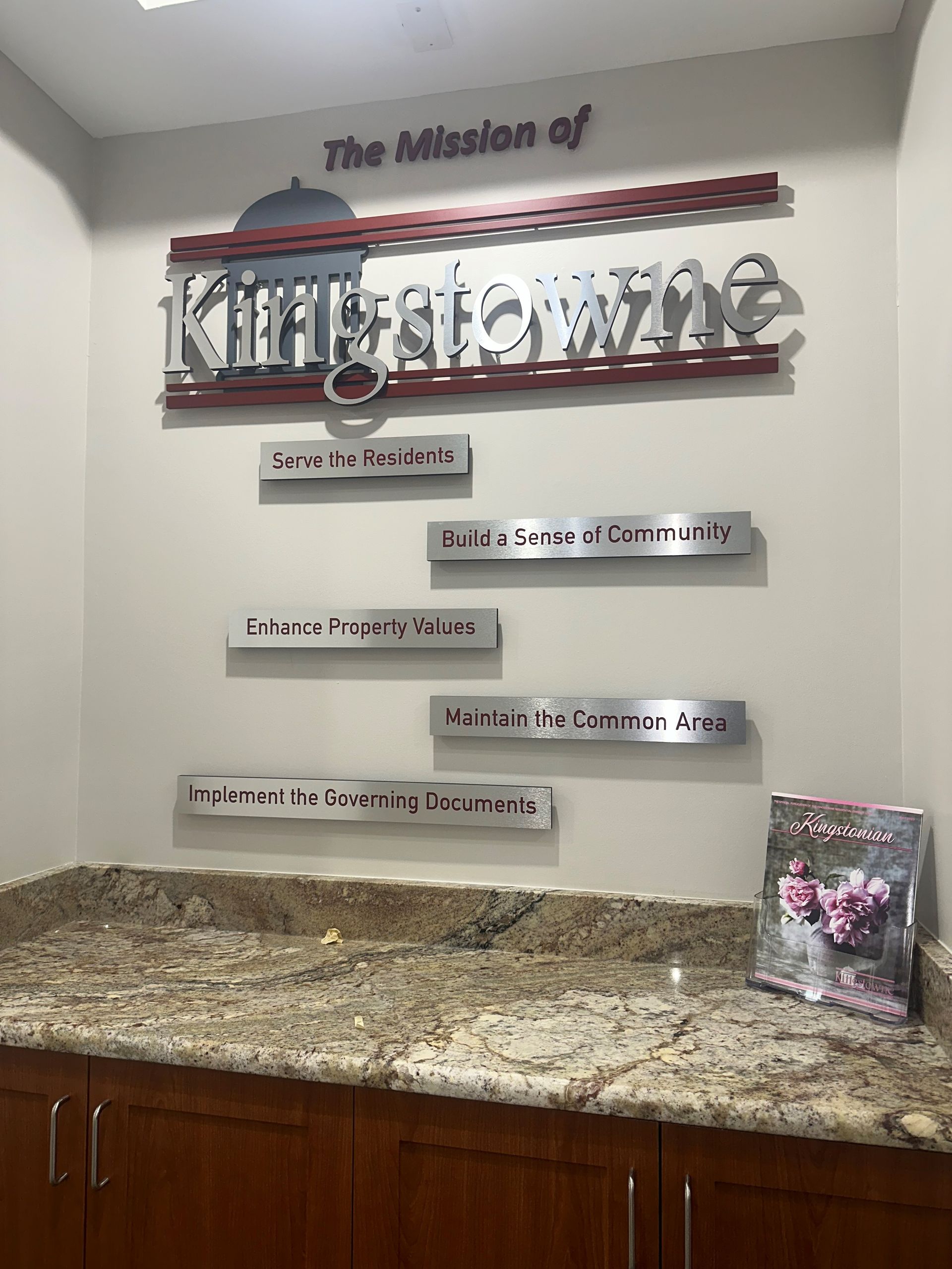 The mission of kingstown is displayed on a wall above a counter
