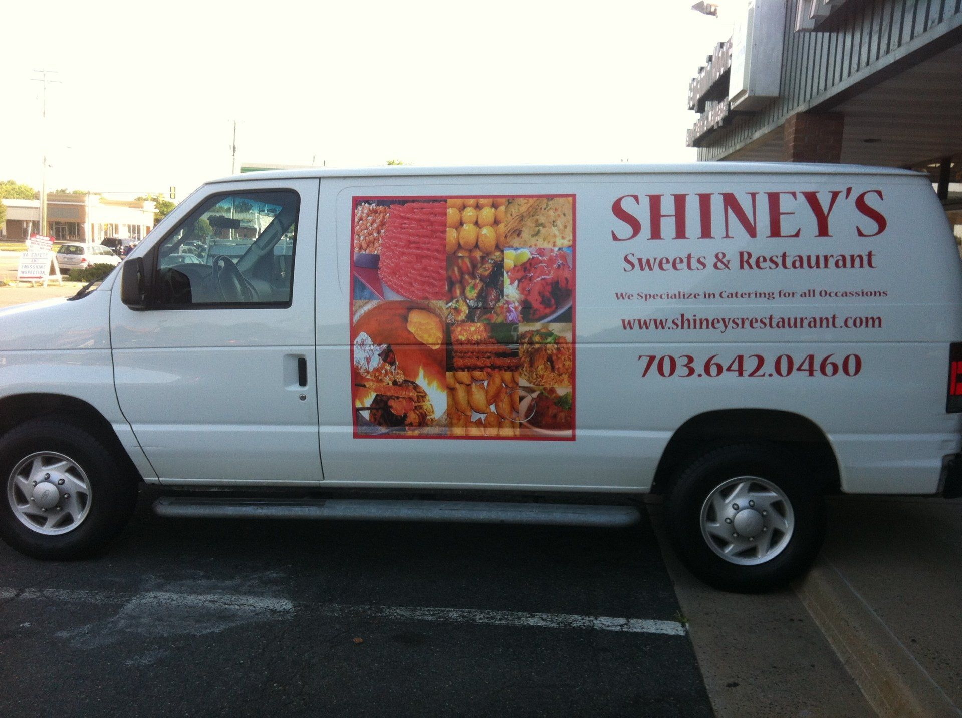 A white van that says shiney 's sweets & restaurant