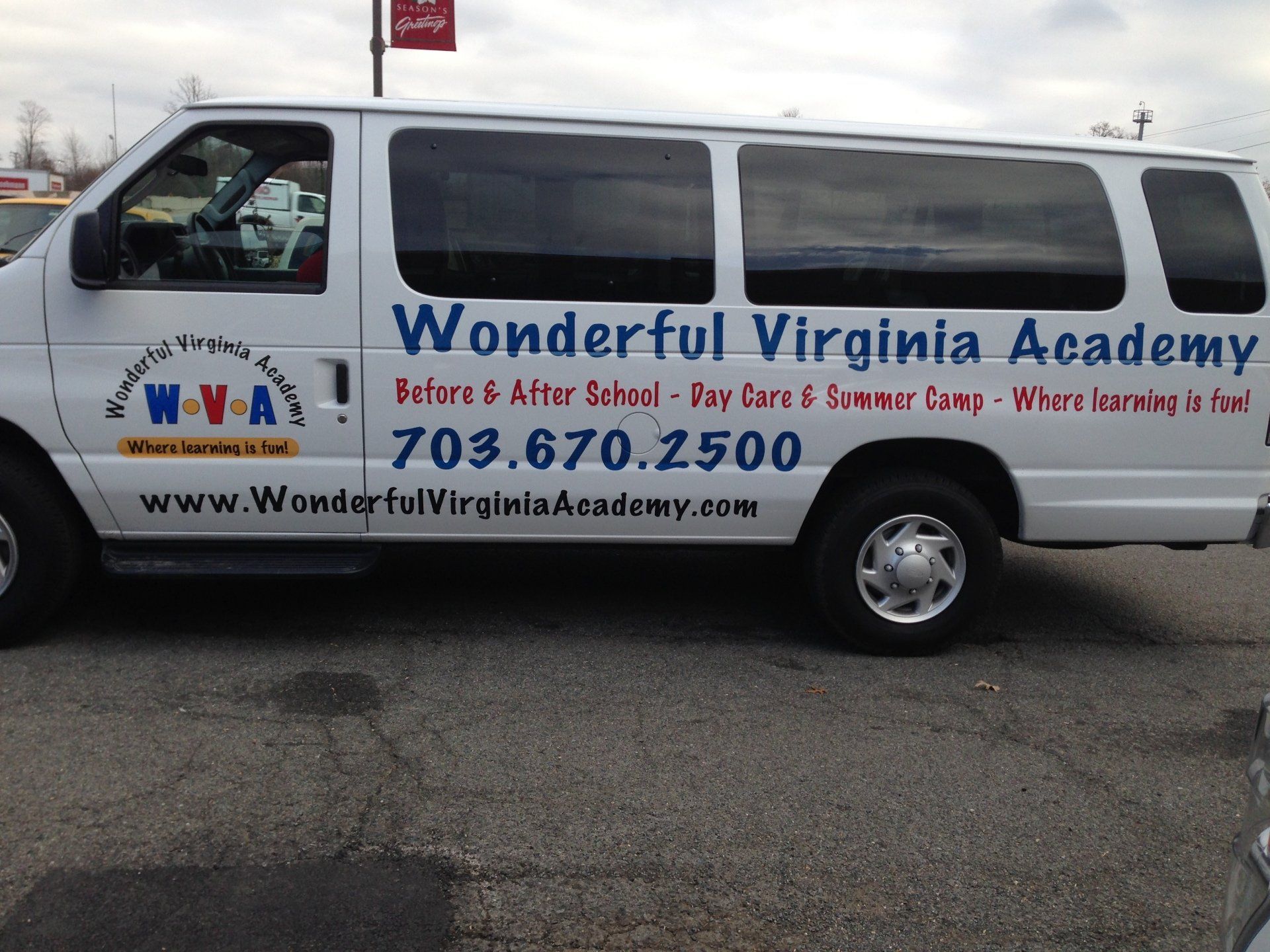 A white van with wonderful virginia academy written on the side