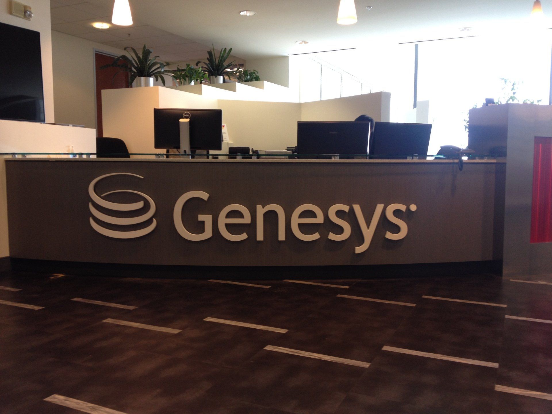 A genesys sign is on a counter in an office