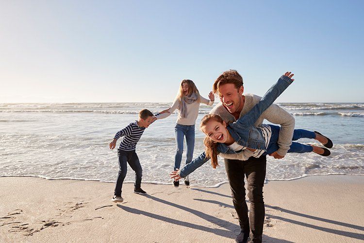 Parents with Children Having Fun on Beach ─ Grand Island, NE ─ Bradley Law Firm, PC