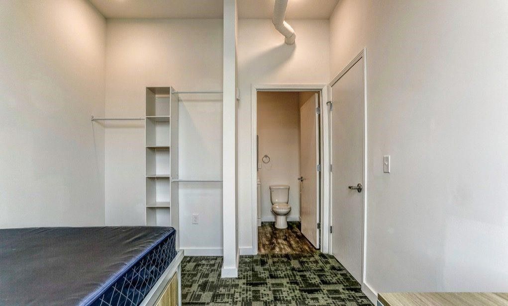 Photo showing a master bedroom and bathroom