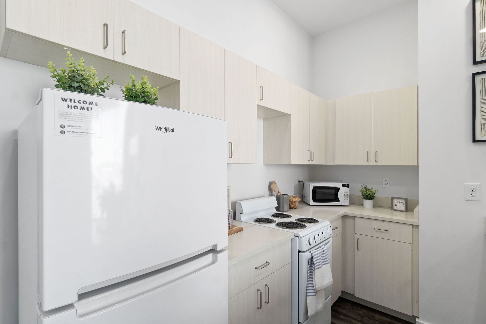 1-Bedroom Student Apartments in Clarksville, TN | Main608 | Kitchen with White Whirlpool Appliances and Tan Flat-Panel Cabinetry.