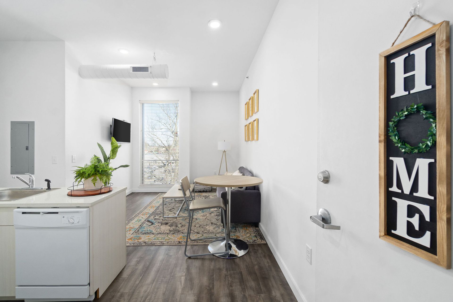 Student Apartments in Clarksville, TN with In-Unit Washer and Dryer | Main608 | Open Layout of Kitchen and Living Room with Wood-Style Flooring.