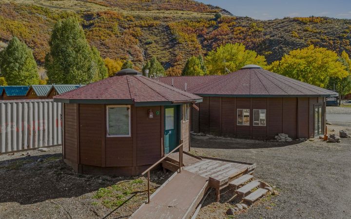 A couple of small houses with a ramp in front of them.