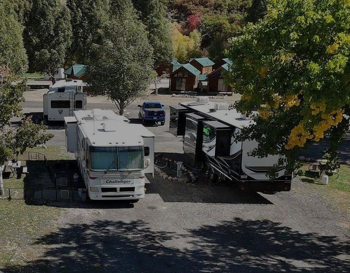 A group of rvs are parked in a parking lot