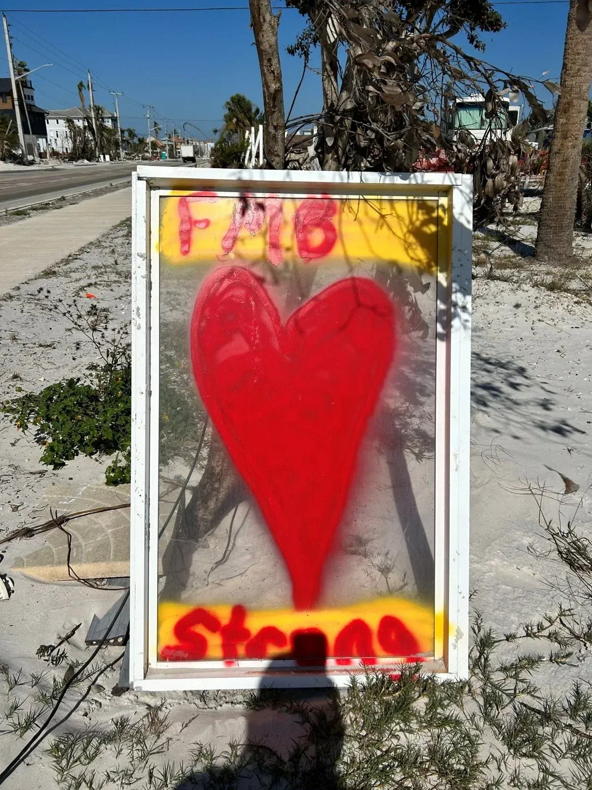 A framed picture of a red heart with the words fab stenciled on it