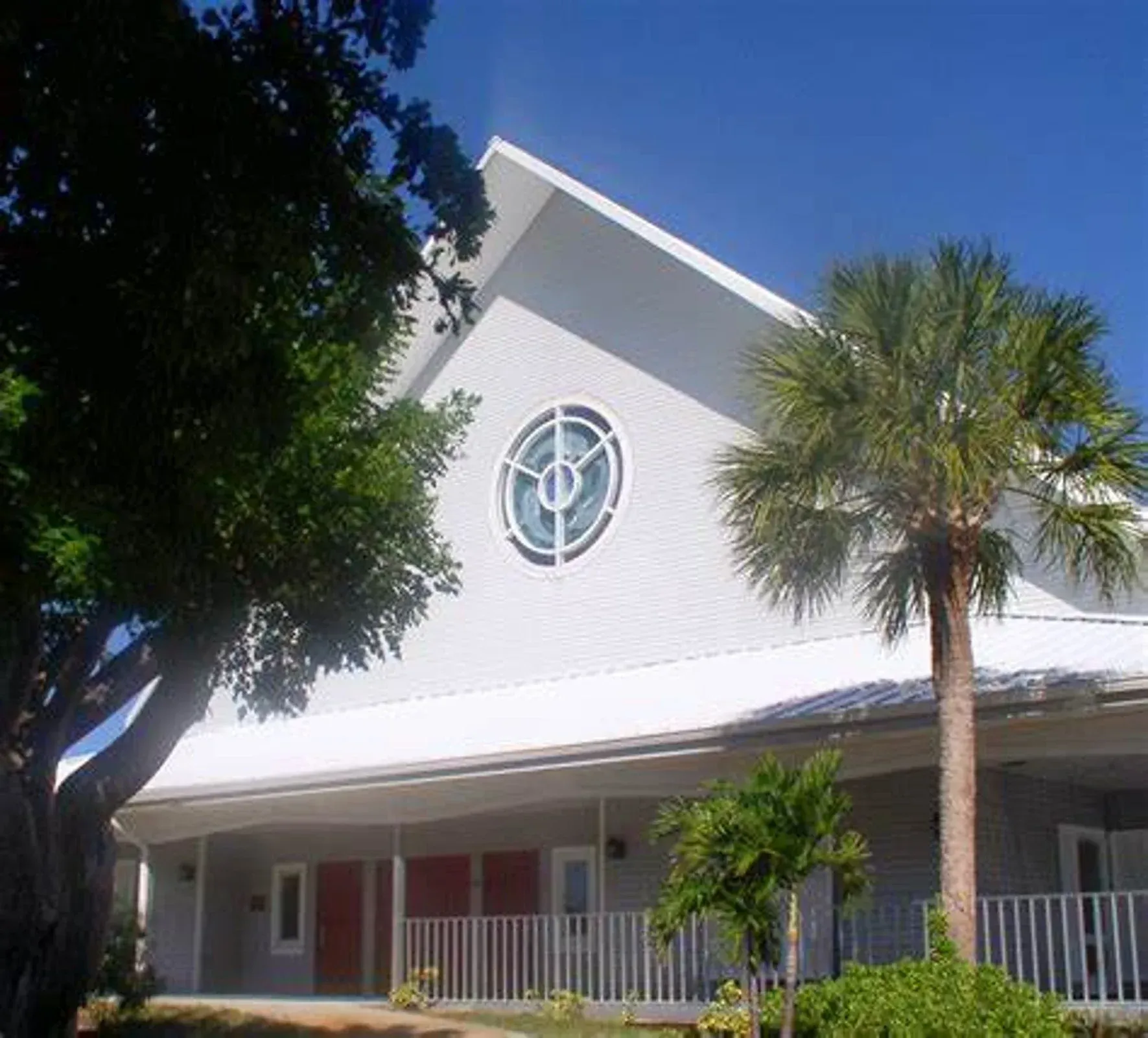 A white building with a circular window on the side