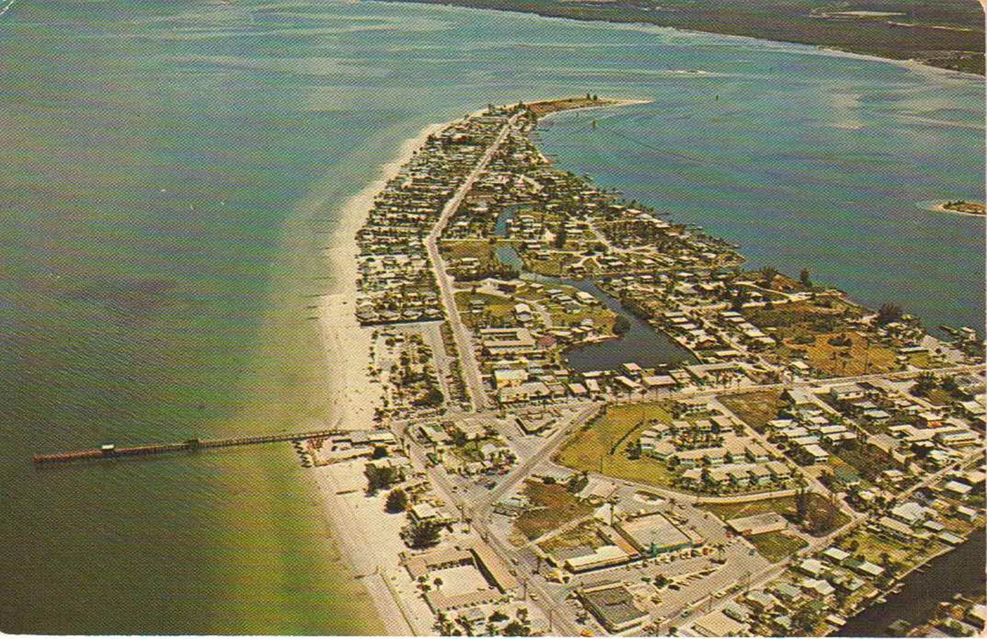 An aerial view of a city surrounded by water