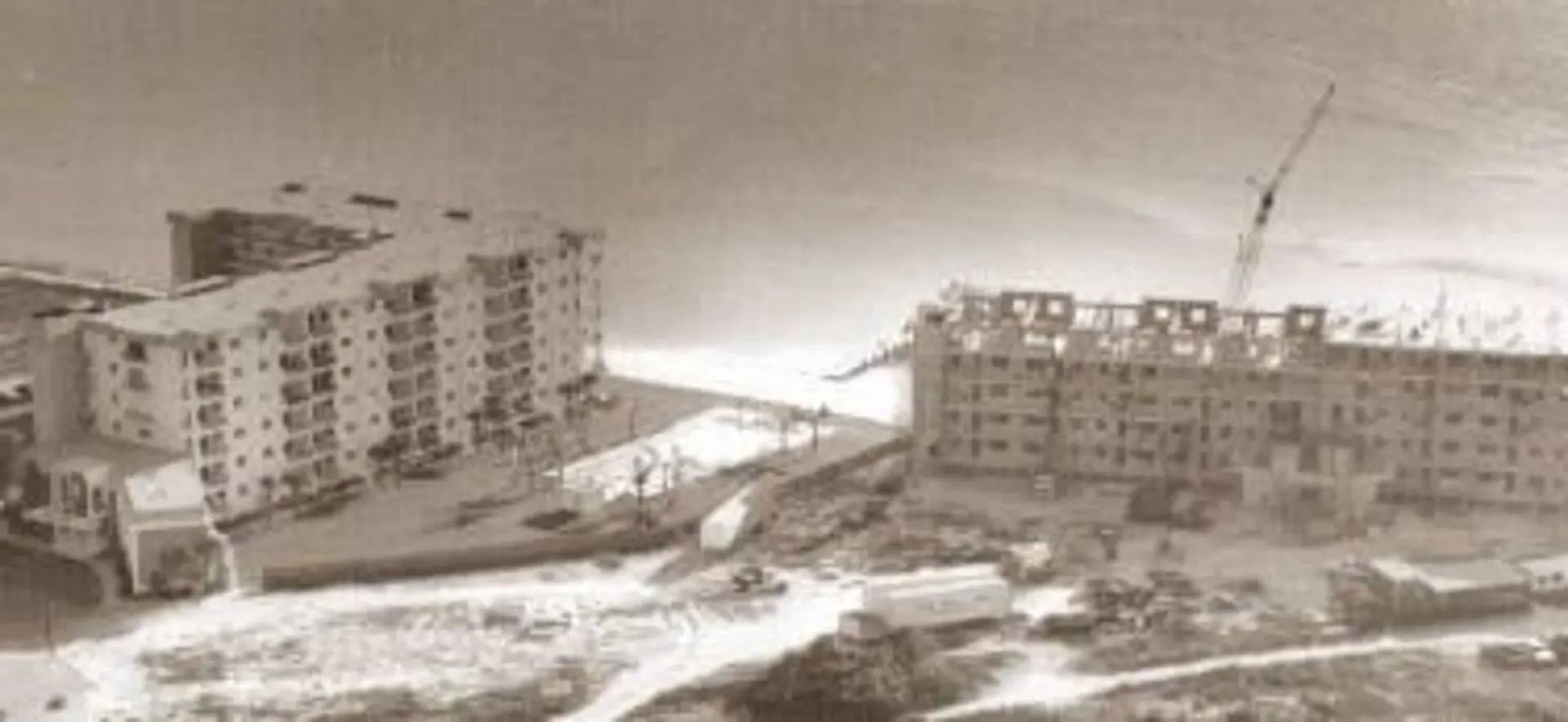 A black and white photo of a building under construction.