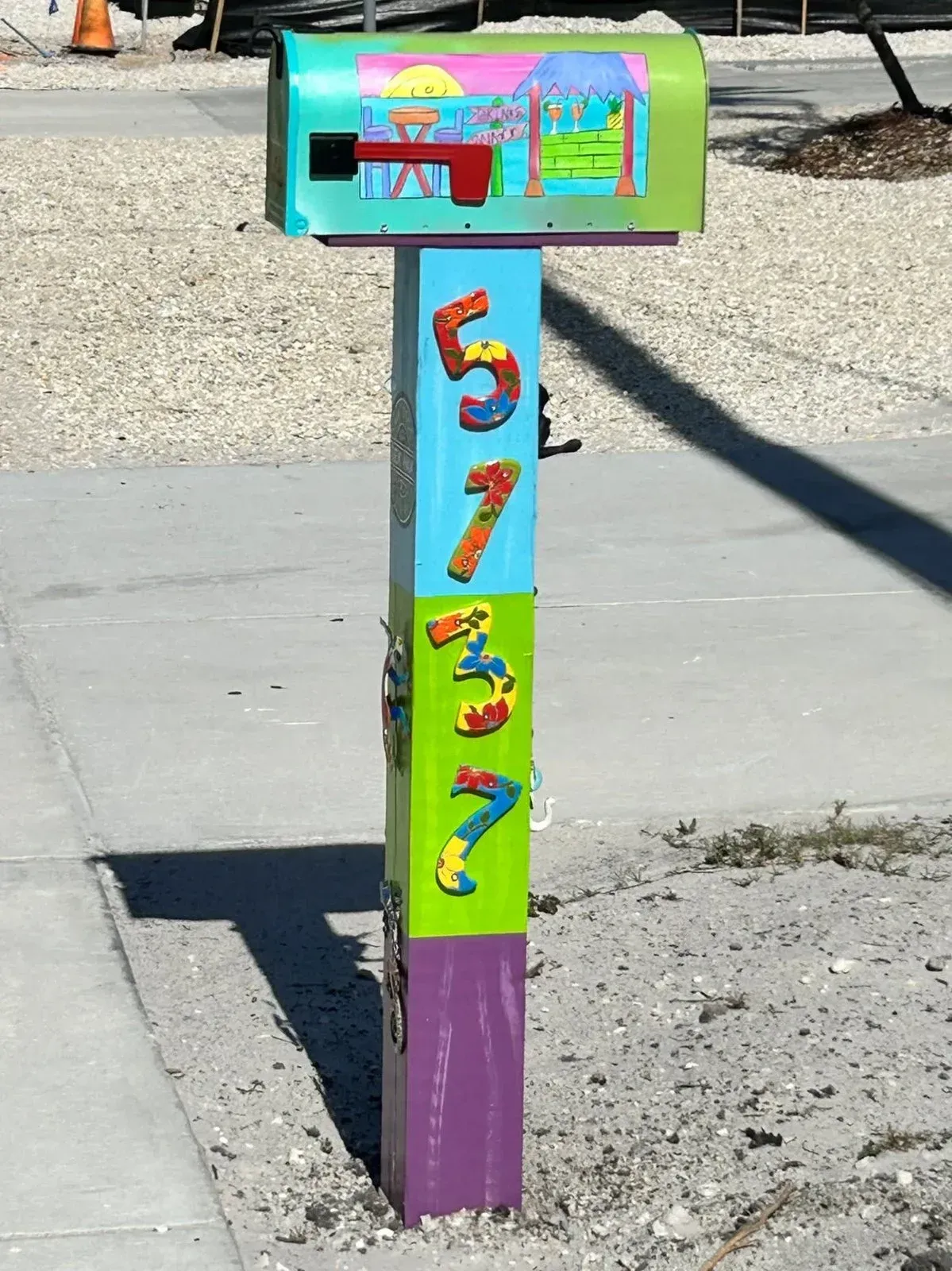 A colorful mailbox with the number 5 on it