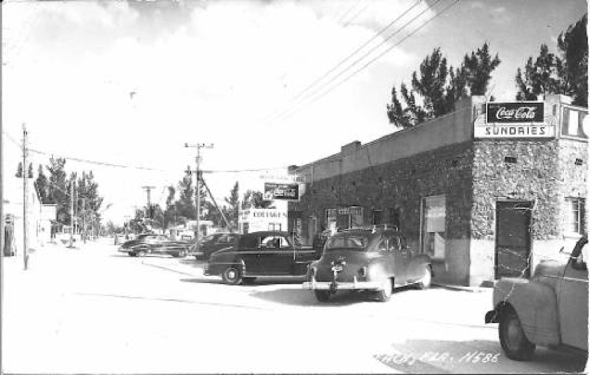 A black and white photo of a coca cola laundromat
