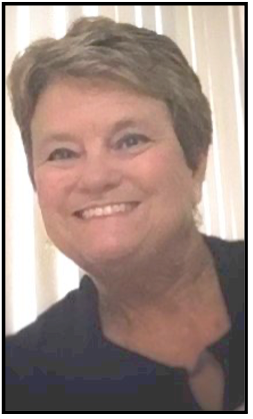 Woman with short gray hair smiling, wearing a dark shirt.