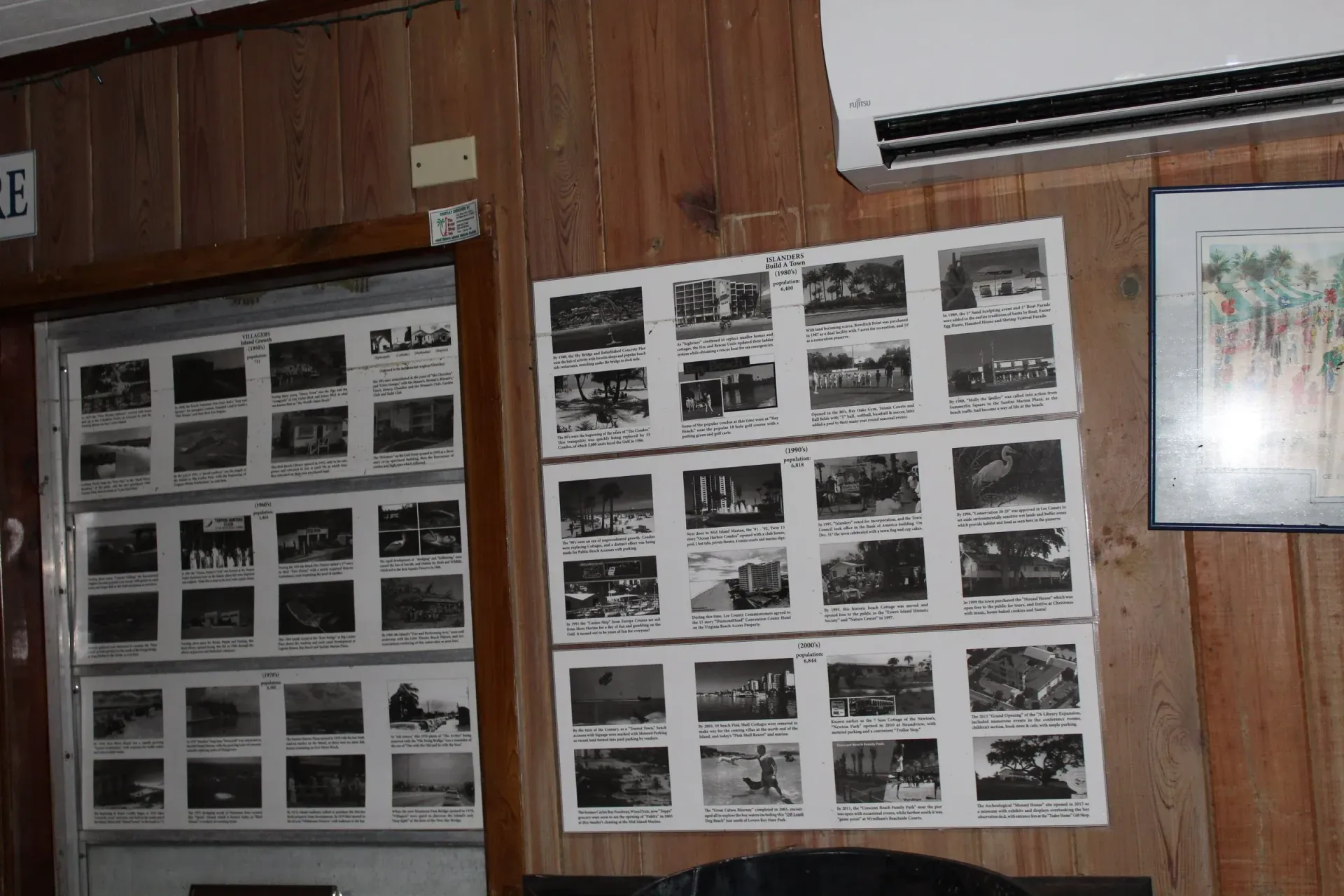 A wooden wall with a bunch of pictures on it