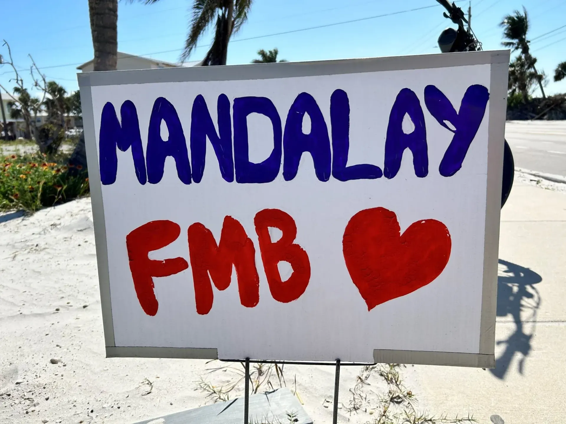 A sign that says mandalay fmb on it