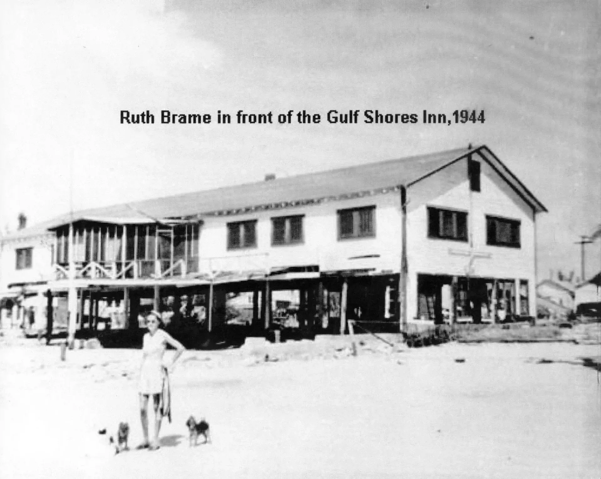 A black and white photo of ruth brame in front of the gulf shores inn in 1944