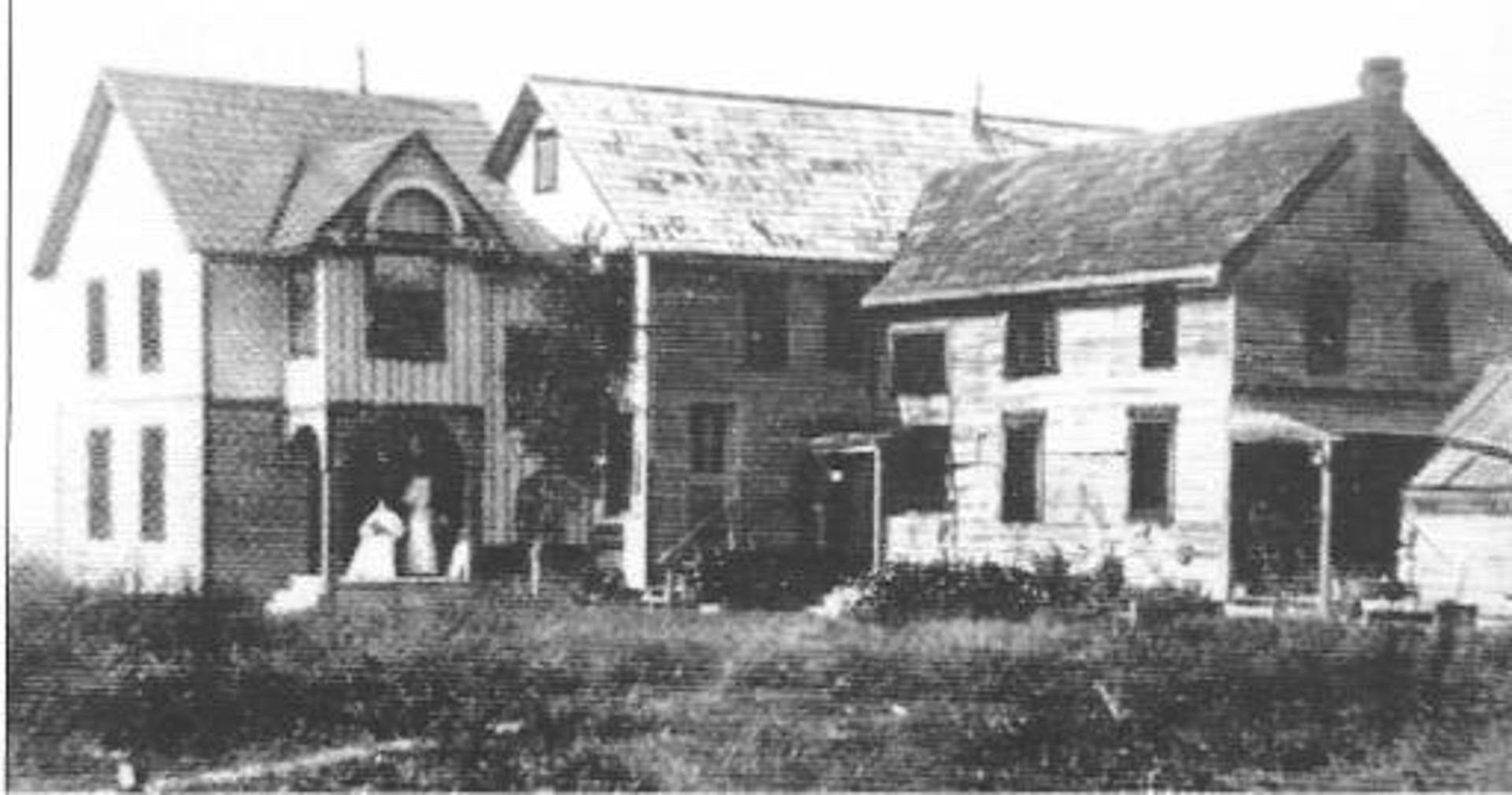 A black and white photo of a row of houses