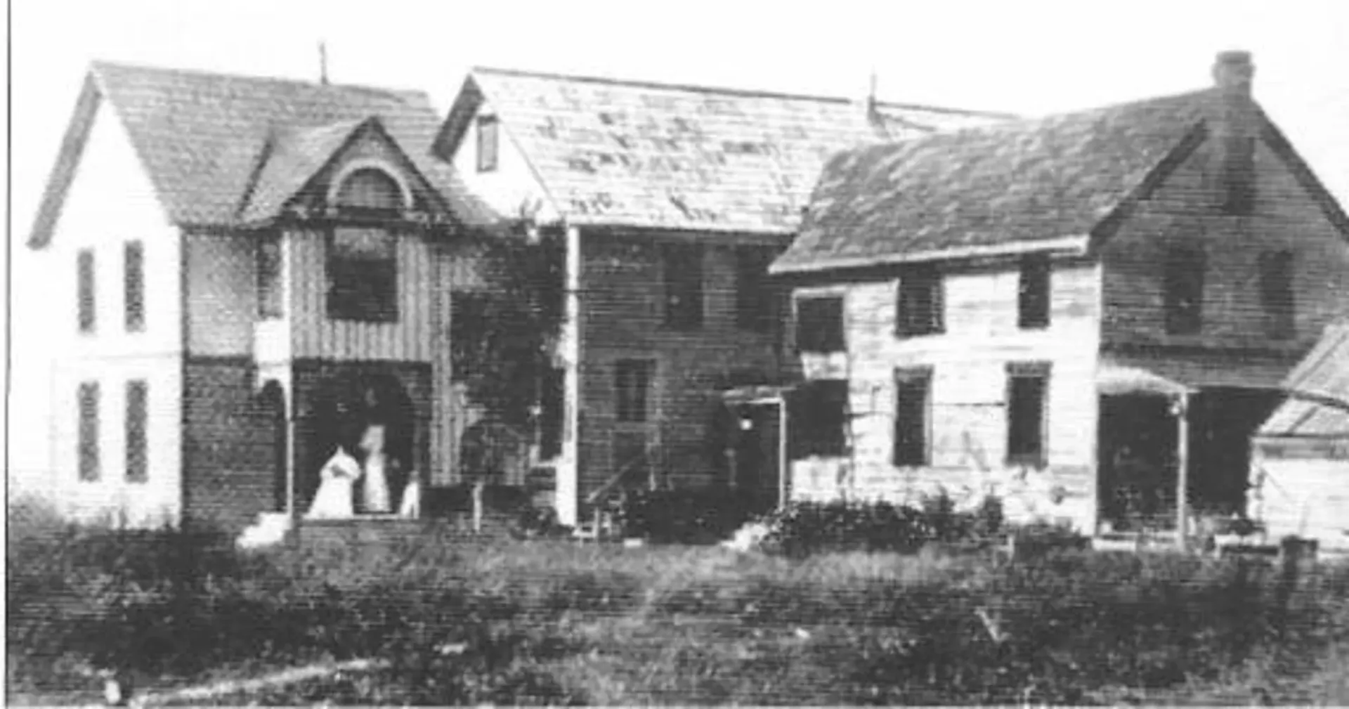 A black and white photo of a row of houses