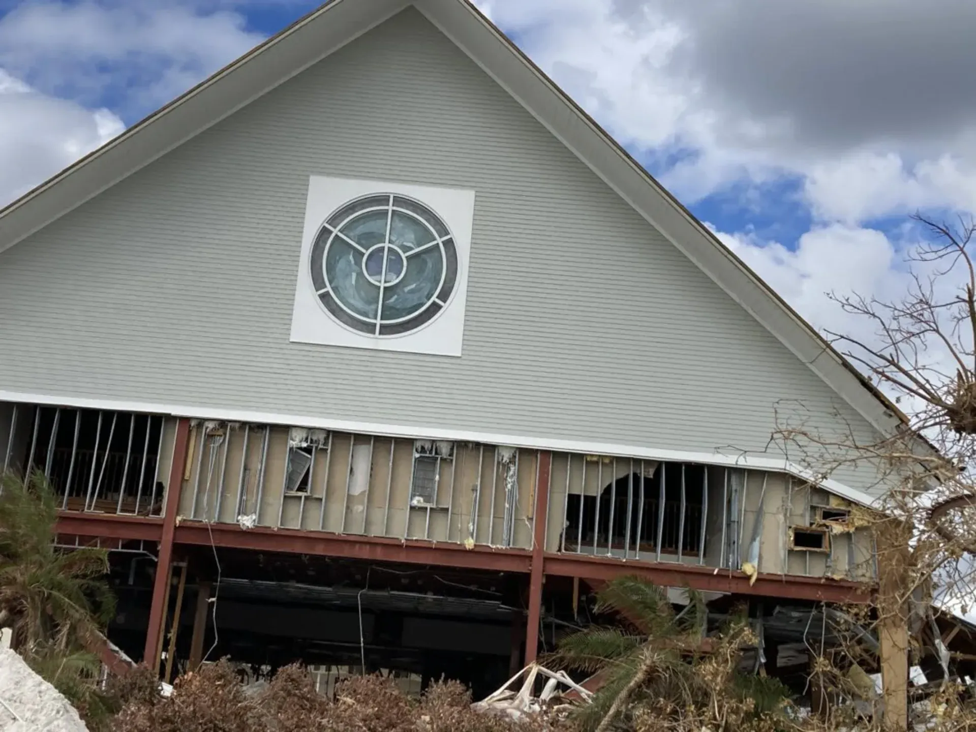 A white house with a target on the side of it.