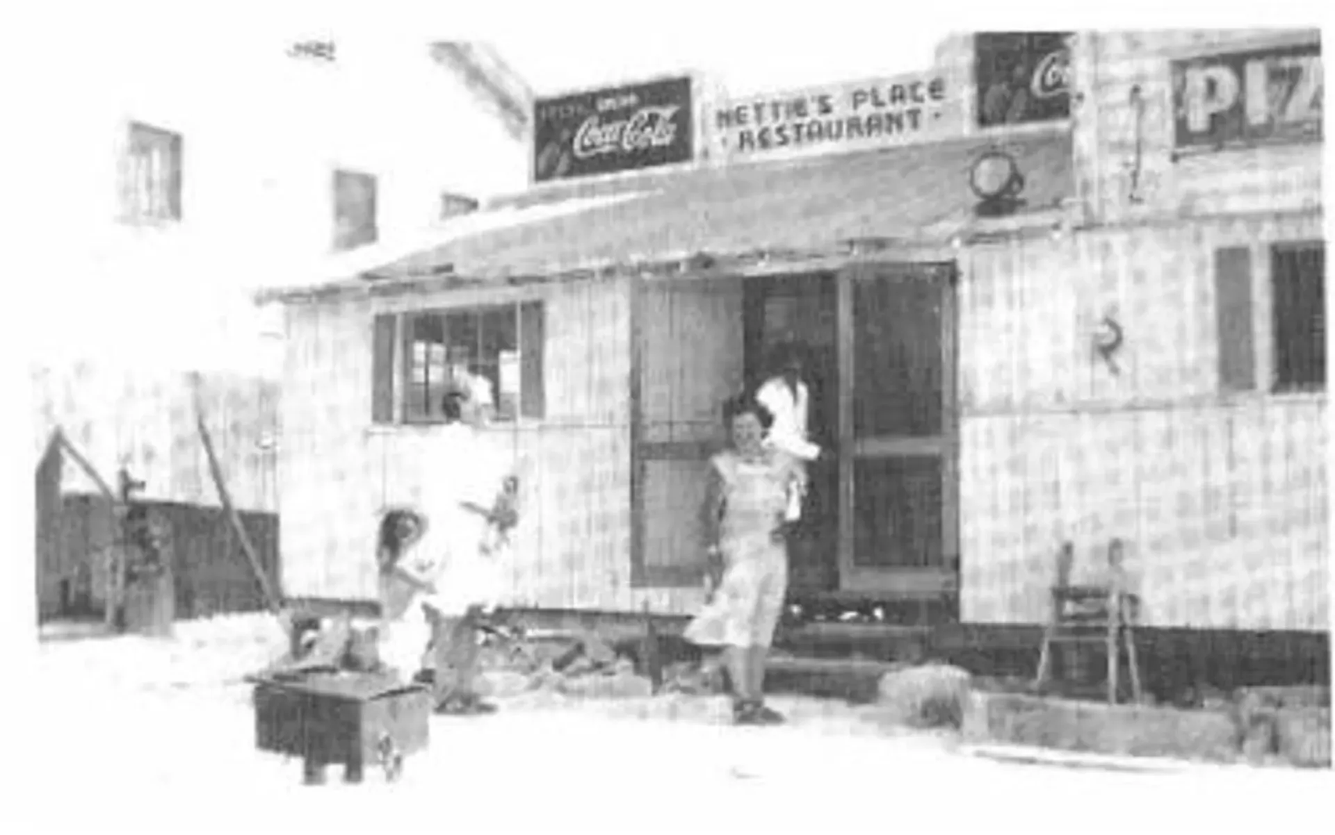 A black and white photo of a coca cola restaurant