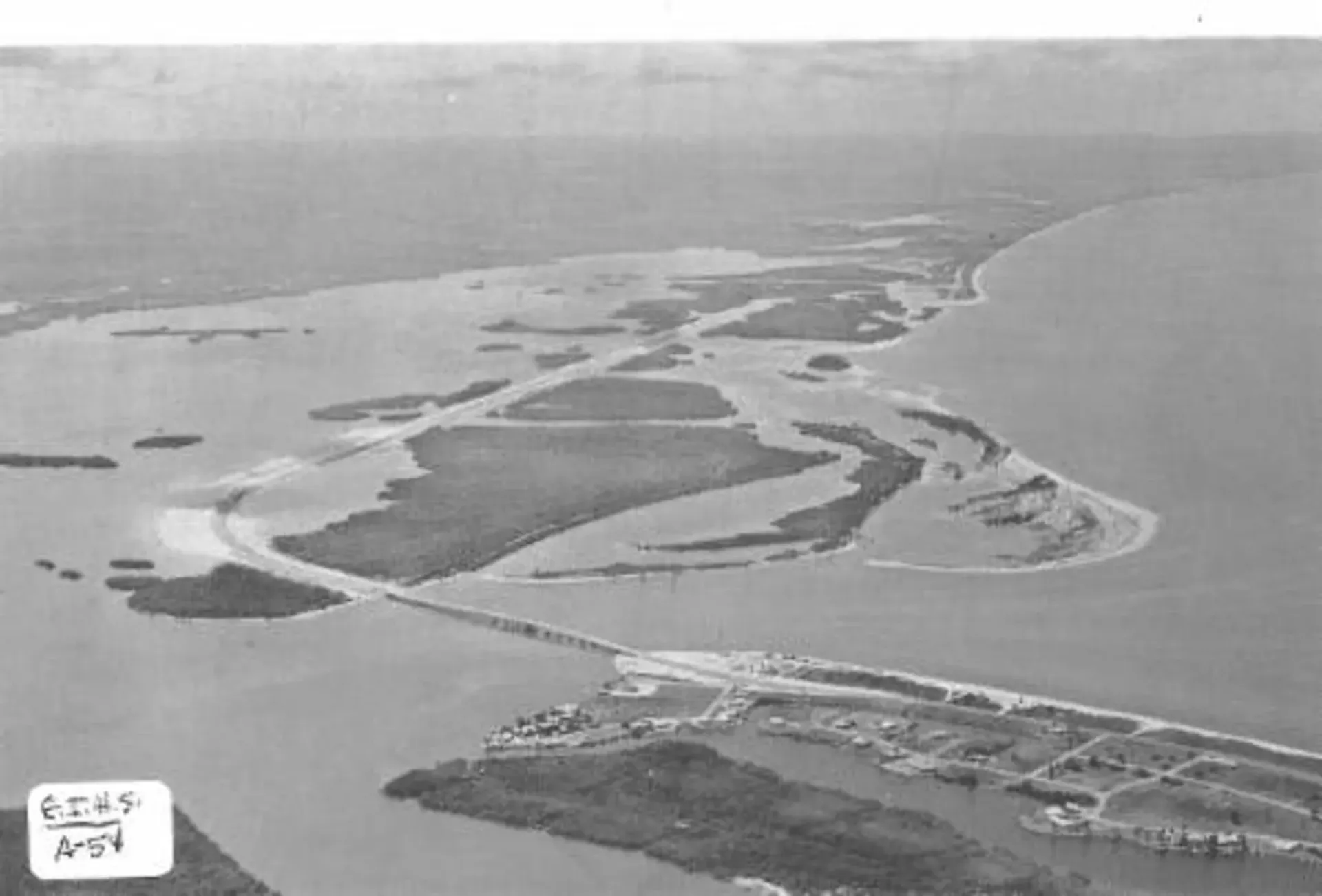 An aerial view of a small island in the middle of a body of water.