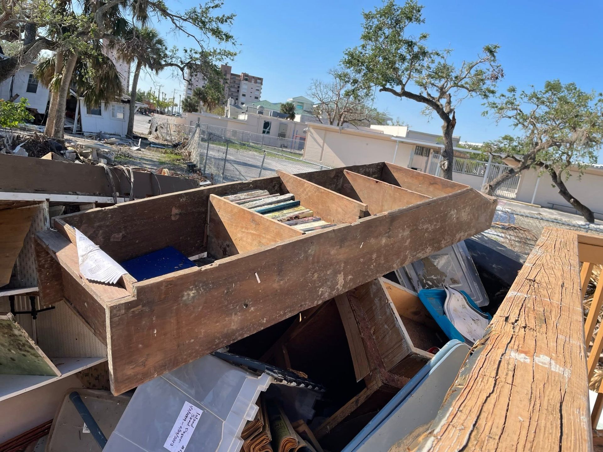 A pile of wood is sitting on top of a pile of cardboard boxes.