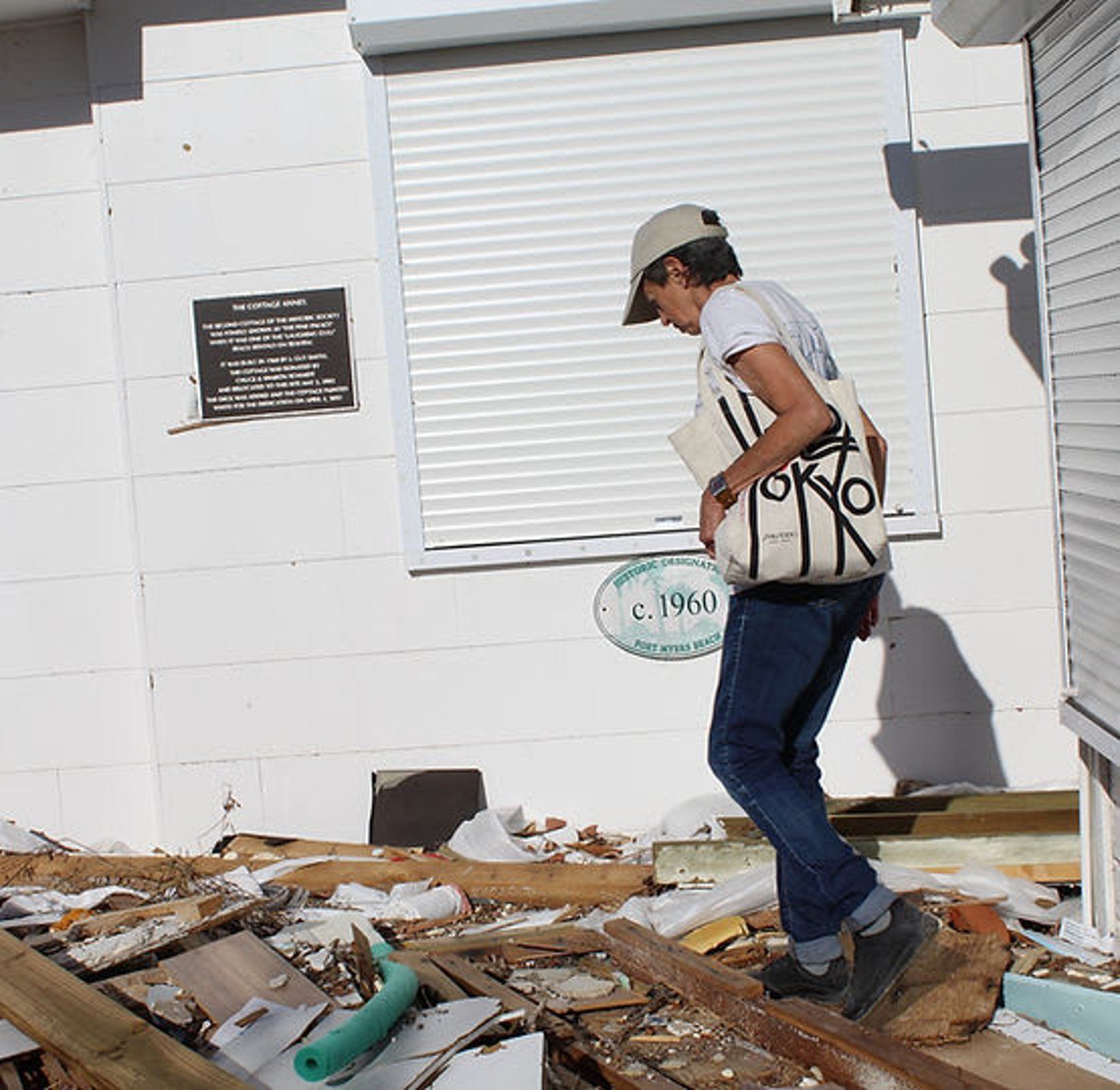 A man standing in front of a building with a sign that says 1960