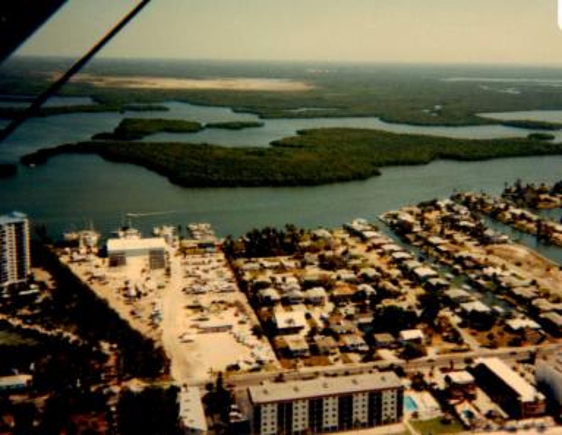 An aerial view of a city with a large body of water in the background